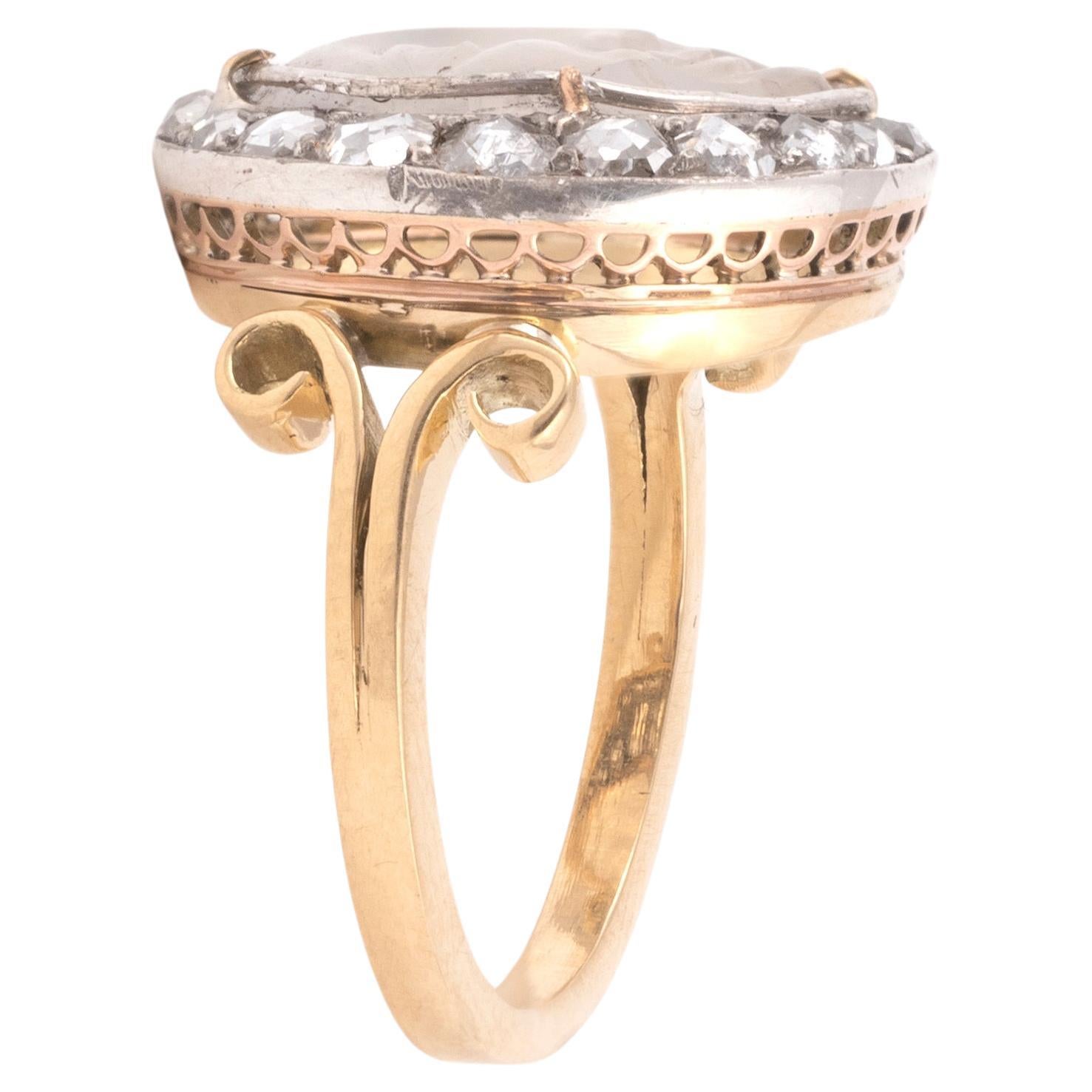 A late 19th century man in the moon ring, set in silver and gold with a carved moonstone within a rose diamond. On a gold reeded shank with bifurcated shoulders and gold under bezel.
English, mid to late 19th century.
Diameter 2cm / ¾''
Size