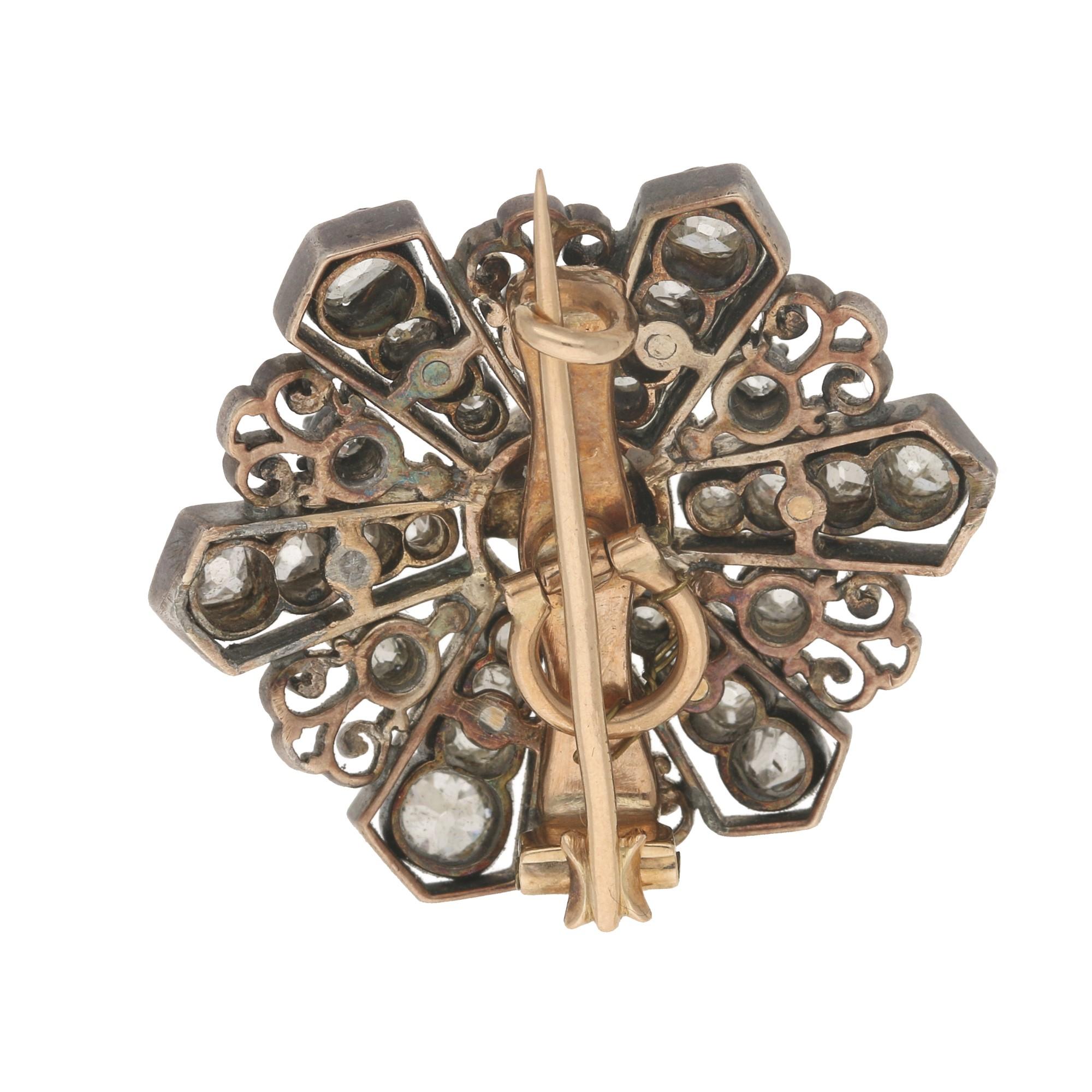 A beautiful Victorian diamond and pearl star brooch set in silver-on-gold. 

This lovely little piece is centrally set with a singular cream pearl. From this central pearl six panels of graduating old mine cut diamonds spray out. In-between each