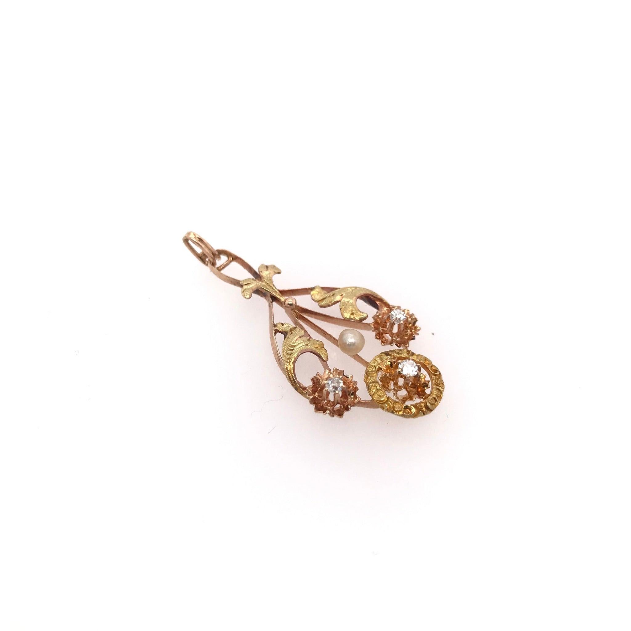 This antique Lavalier style pendant was handcrafted during the Victorian Era ( 1840's-1900 ) The pendant is crafted from 14k victorian rose gold. This antique piece has charming 14k green gold floral accents, indicative of the romantic design