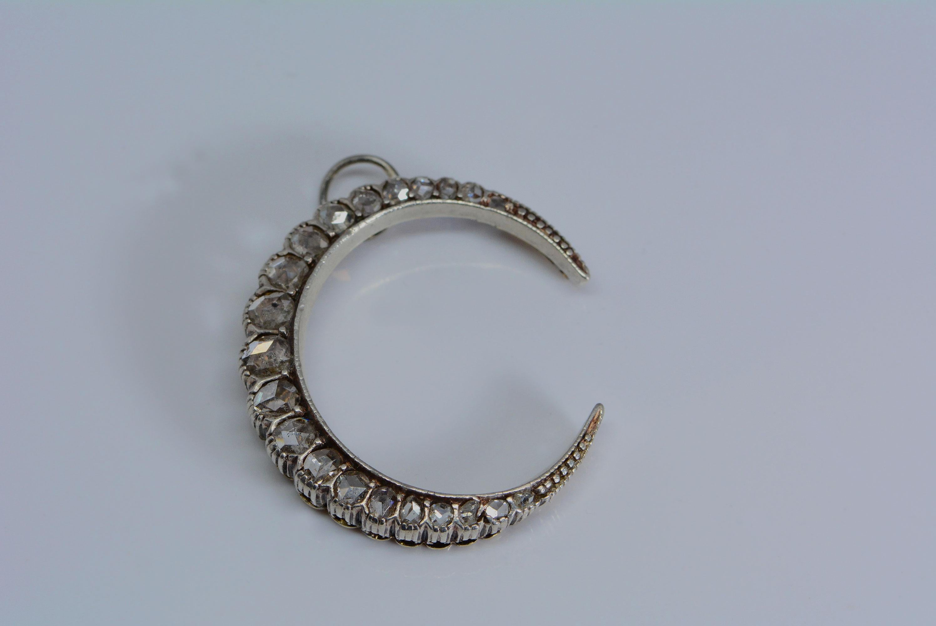 This beautiful crescent represents the moon goddess, (Artemis, Diana Triformis, Luna) glowing and divine. 

Most crescent jewels are typically silver backed with yellow gold or made entirely out of yellow gold. 
This crescent is made from platinum