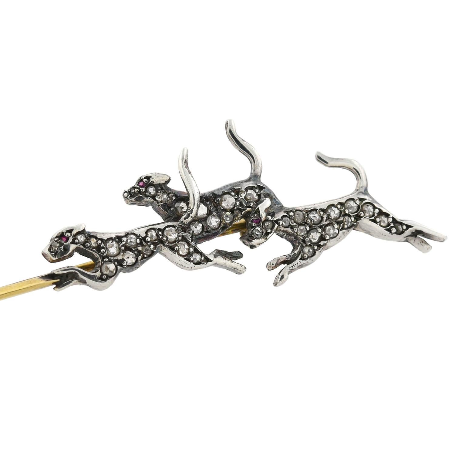A unique pin from the Victorian (1880s) era! Crafted in 14kt yellow gold topped with sterling silver, this sport-inspired piece features a fox being chased by three hunting hounds. The sterling topped animals appear in motion, with the fox at one