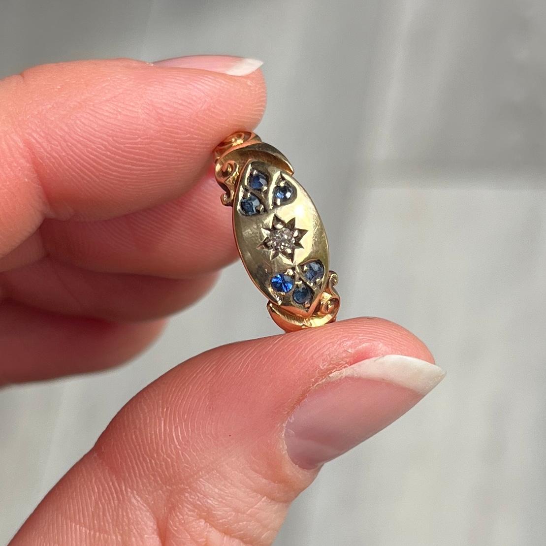This ring holds a diamond at the centre measuring approx 5pts in a star setting and two trios of diamonds measuring 9pts per trio. Fully hallmarked Birmingham 1901.

Ring Size: O or 7 1/4
Band Width: 8mm

Weight: 3.4g