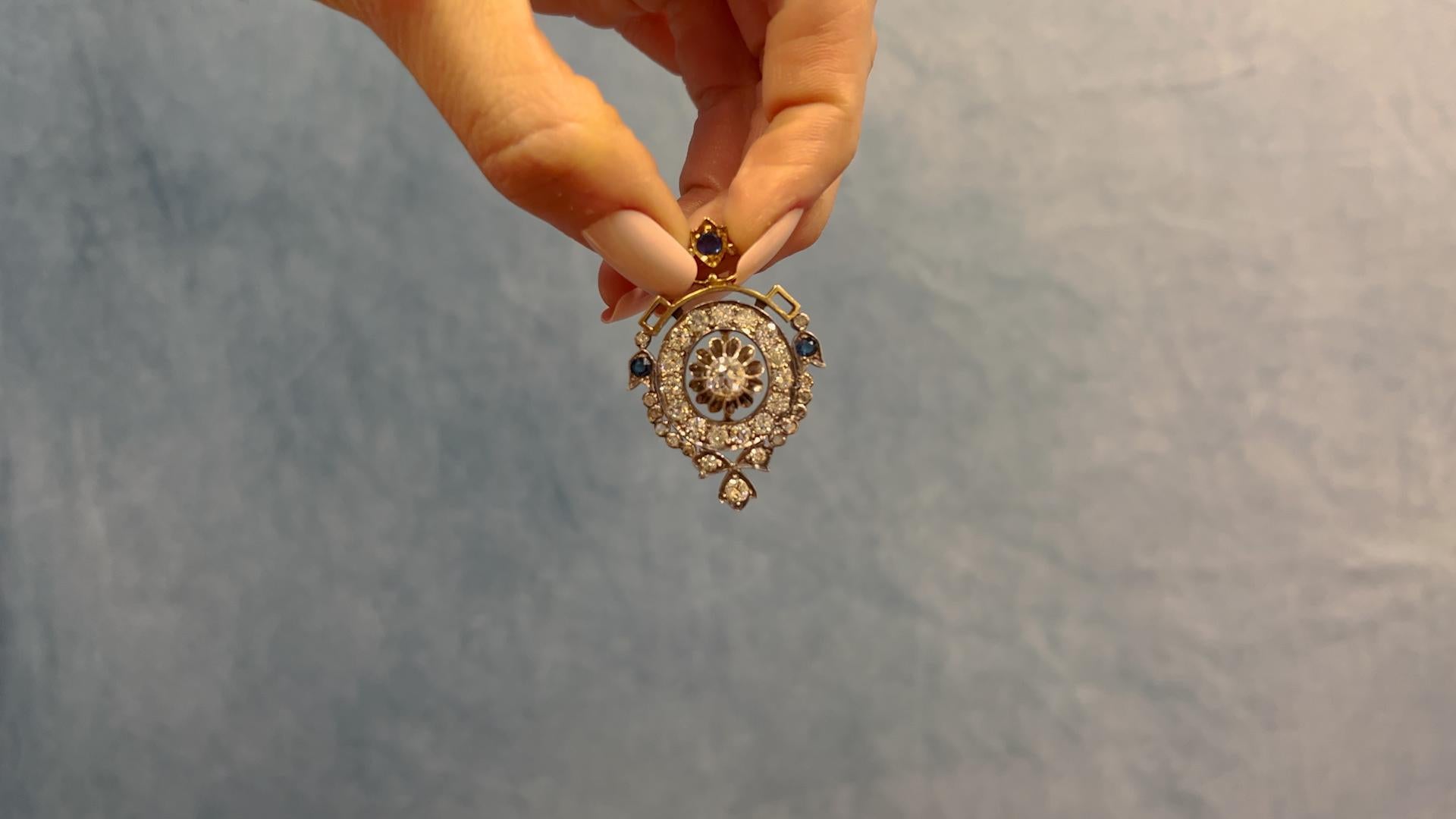 One Victorian Diamond and Sapphire 18k Yellow Gold Silver Pendant. Featuring one old European cut diamond of approximately 0.80 carat, graded H color, SI1 clarity. Accented by 30 old European and senaille cut diamonds with a total weight of
