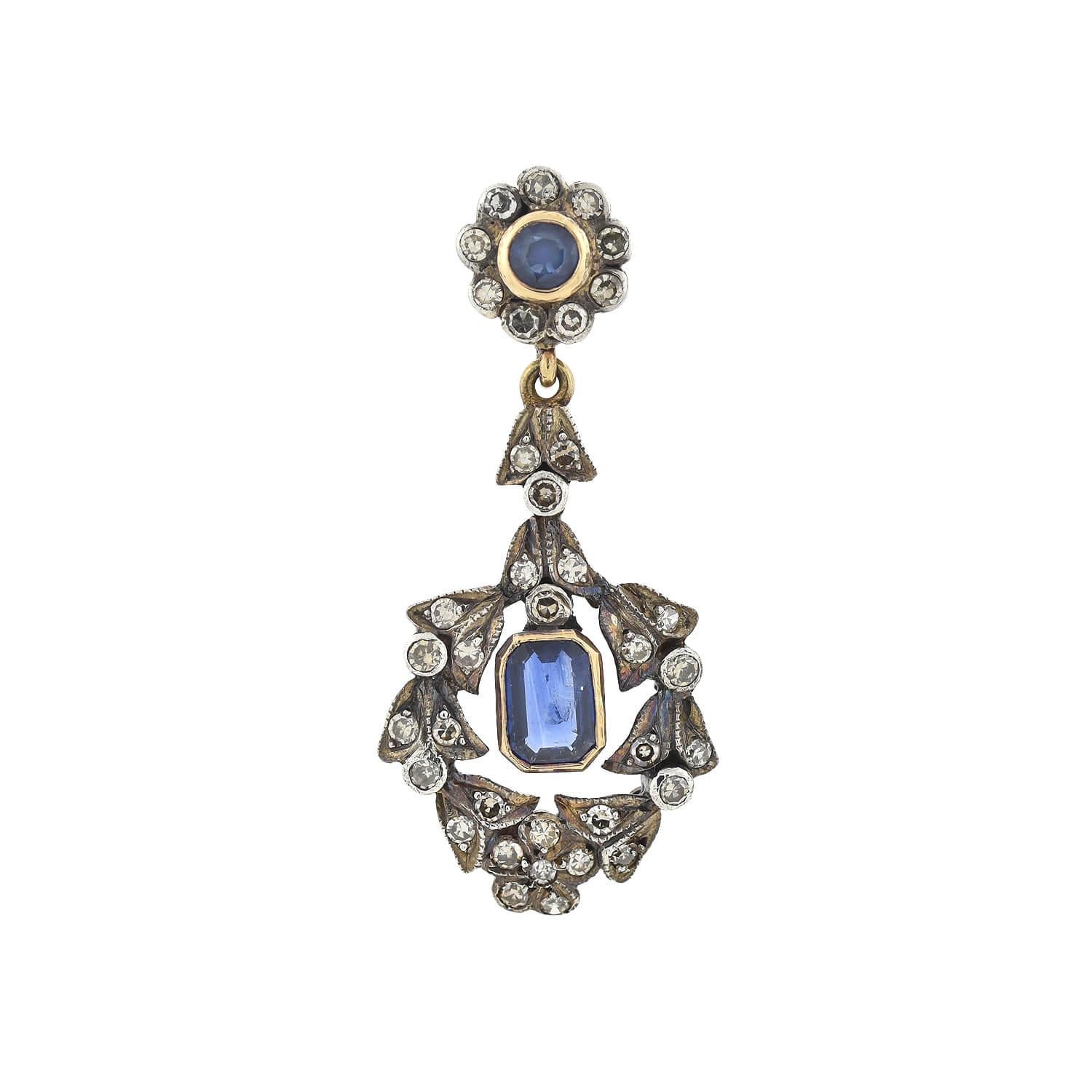 A gorgeous pair of diamond and sapphire earrings from the Victorian (ca1880s) era! Crafted in 18kt yellow gold and topped in sterling silver, these lovely earrings begin with a Round Cut sapphire in a yellow gold bezel surrounded by nine Single Cut