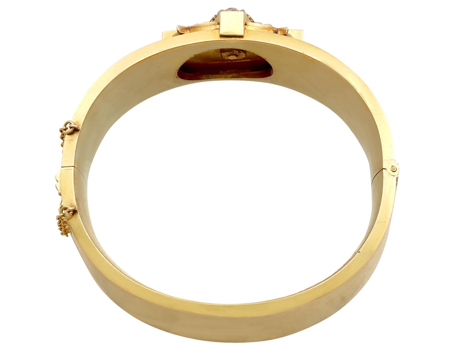 An exceptional and stunning antique 0.38 carat diamond and seed pearl embellished Victorian bangle in 20k yellow gold; part of our bangle and bracelet collection

This stunning Victorian bangle has been crafted in 20k yellow gold.

The feature