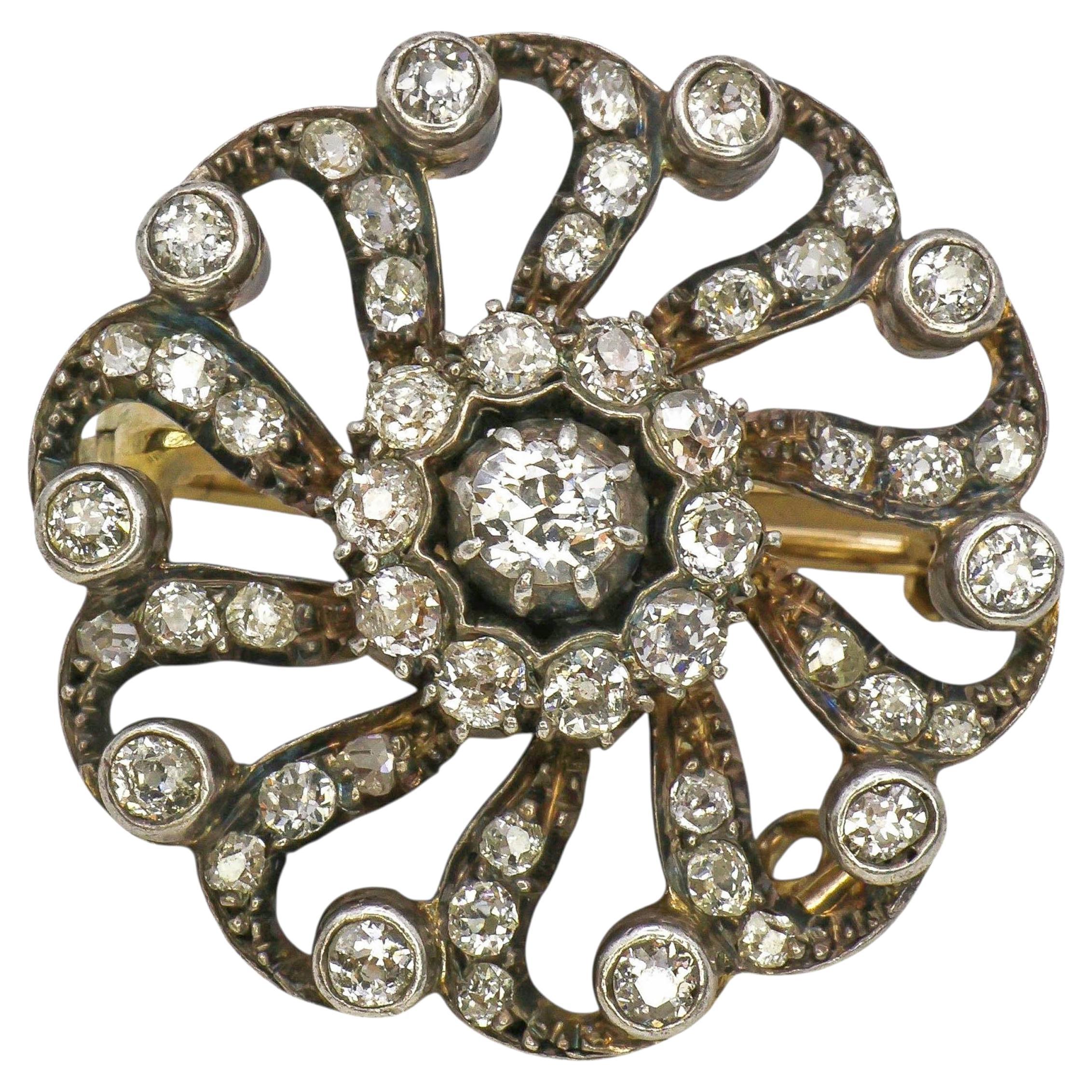 Victorian Diamond and Silver Upon Gold Pinwheel Cluster Brooch, Circa 1890 For Sale
