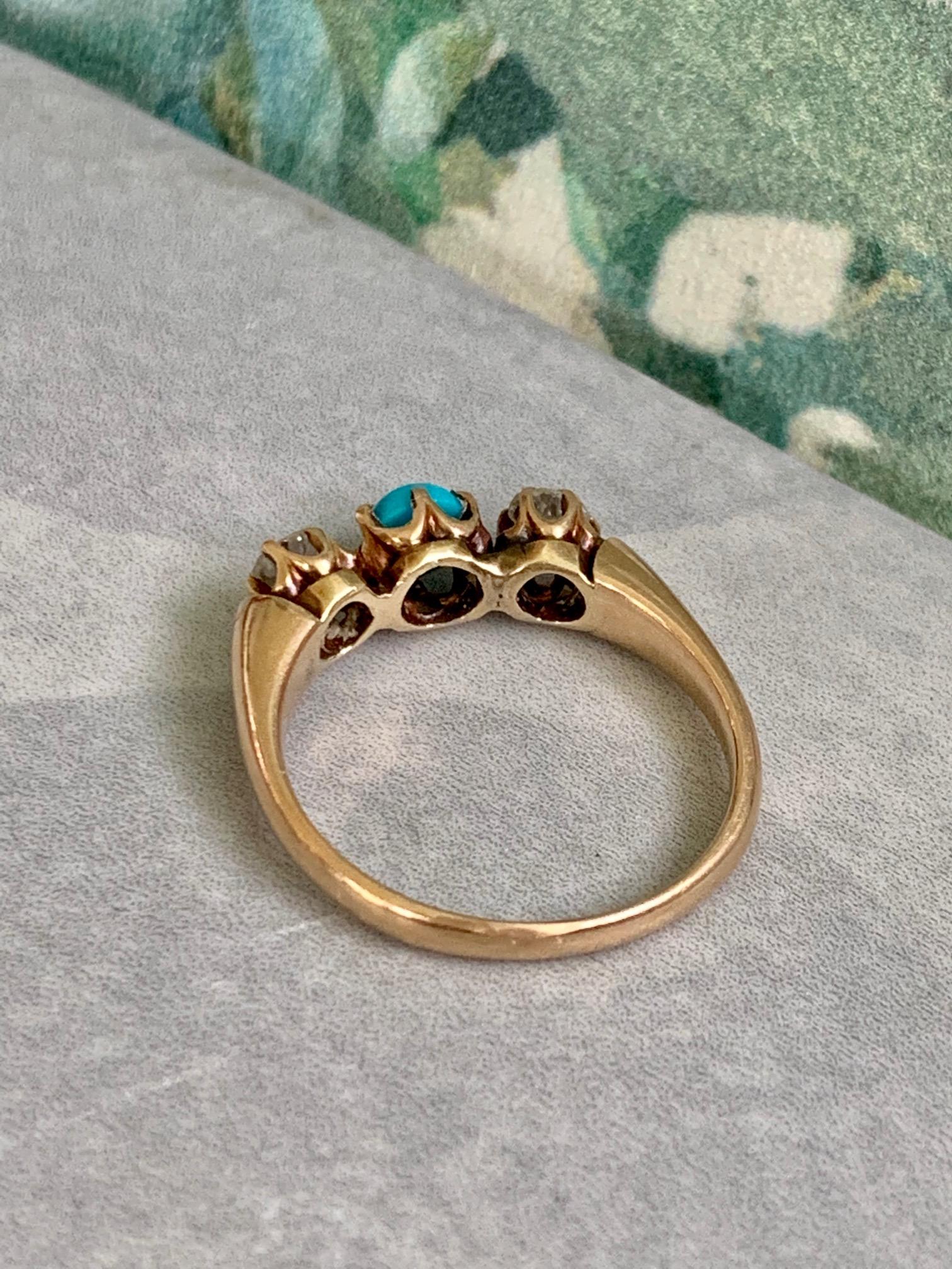 This lovely Victorian Turquoise and Diamond 14 karat yellow Gold ring features two old mine cut Diamonds, set on each side of the Turquoise stone in the center of the ring.  Each Diamond measures approximately 4.2mm each.  They are approximately .35