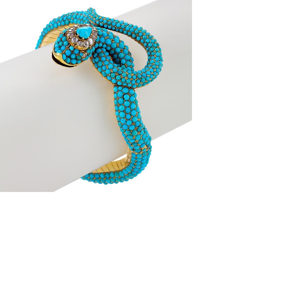 A Victorian 15 karat gold bracelet with turquoise and diamonds. This is a large bangle, to be worn either on the wrist or as an arm band, It has the form of a serpent dynamically wrapped upon itself and seemingly caught in motion, covered in