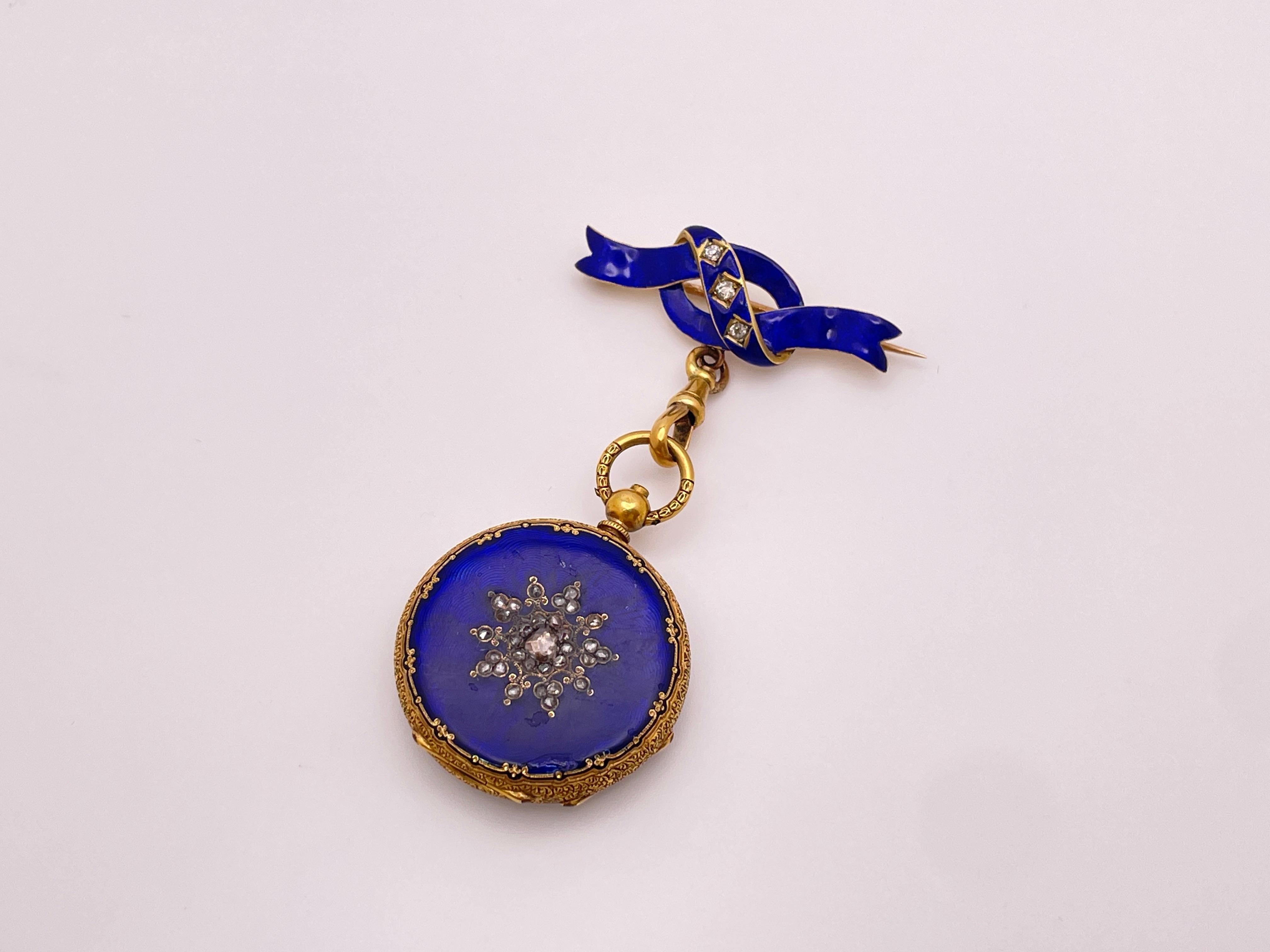 An original Victorian 18K yellow gold diamond blue enamel pendant watch. This magnificent piece features intricate carved 18K gold designs contrasting against the vibrant deep-blue enamel and features beautiful rose-cut diamonds set in a snowflake