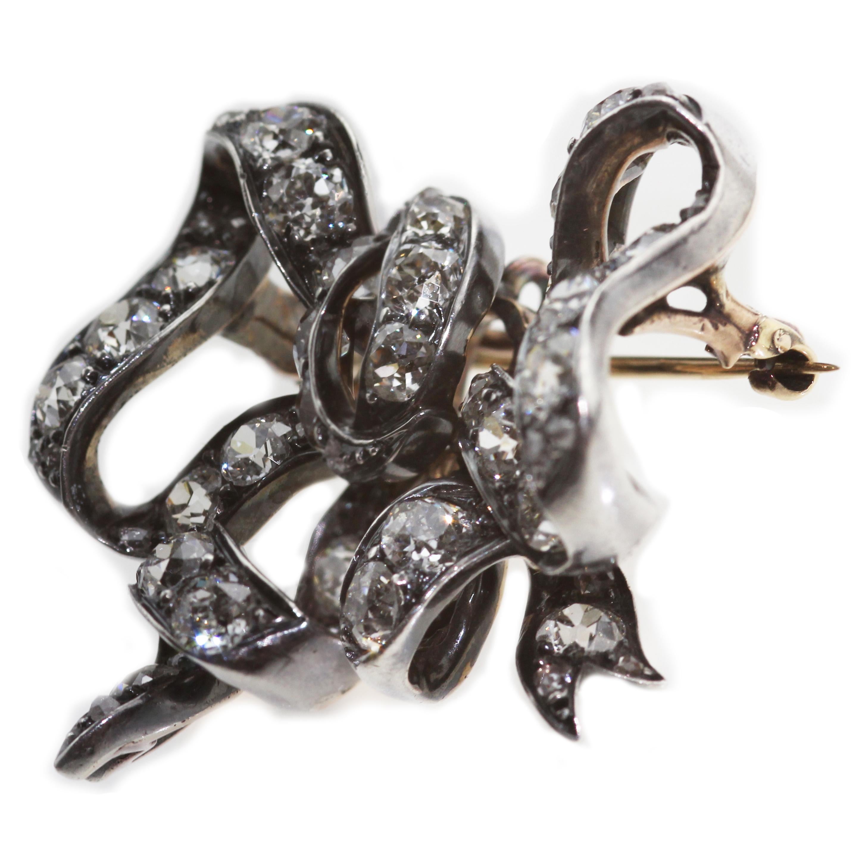A Victorian diamond bow brooch pendant, could be able to wear as a brooch or pendant. Classic Victorian design with raised bow, set in silver top with gold backing. Diamonds are good quality and it is rare to find good quality  diamonds in the