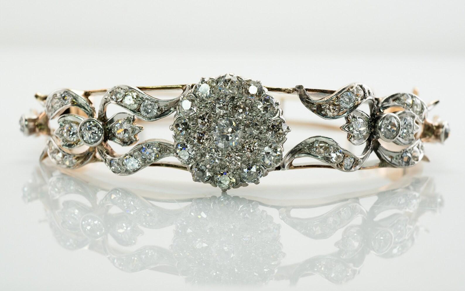 This antique bracelet circa the 1890s is finely crafted in 14K Yellow and White gold. This piece is studded with genuine Old mine cut diamonds. The diamonds vary in size and color/clarity. There are 55 diamonds ranging from SI1 to I2 clarity and H-I
