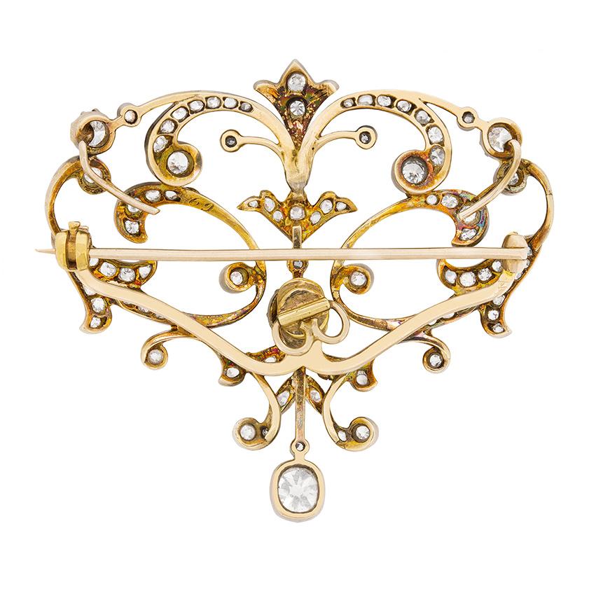 This exquisite brooch is a fine example of Victorian craftsmanship. Dating back to the 1880s, it is carefully handmade from 18 carat yellow gold and silver. Featuring old cut diamonds that are VS2 in clarity and range in colour from G to F. The two