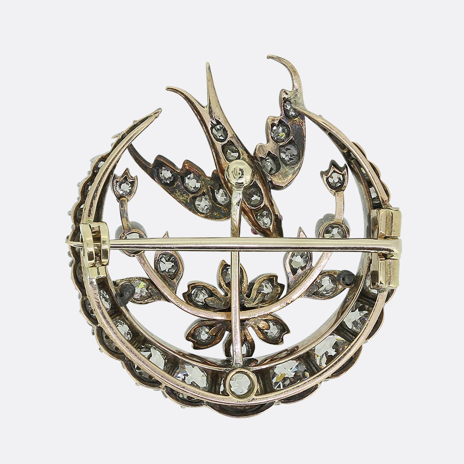 Here we have a delightful diamond brooch dating back to the Victorian period. This antique piece demonstrates excellent attention to detail, firstly, with a crescent shaped frame around the outer edge filled with chunky old cut diamonds which