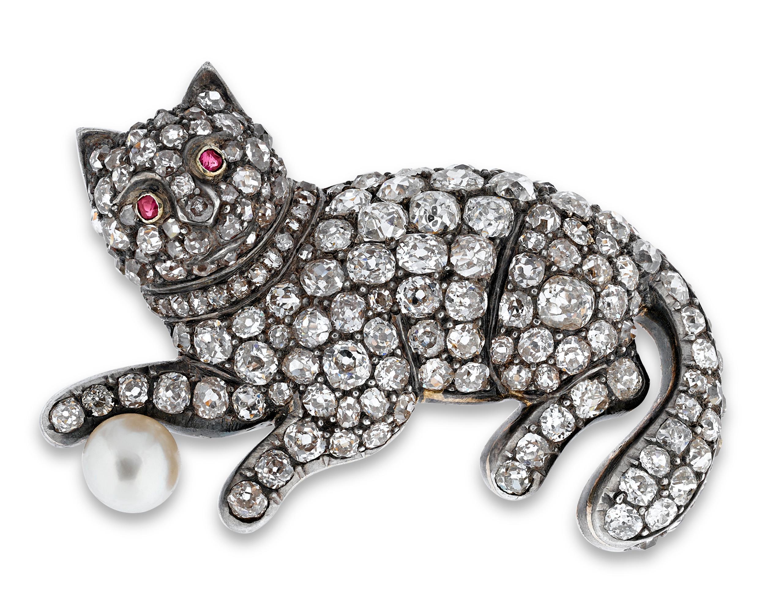 A vision of Victorian charm, this rare period brooch takes the form of a frisky feline. As delightful as it is dazzling, this languorous cat sparkles from head to paw with 4.60 total carats of diamonds, while her red ruby eyes smolder against her