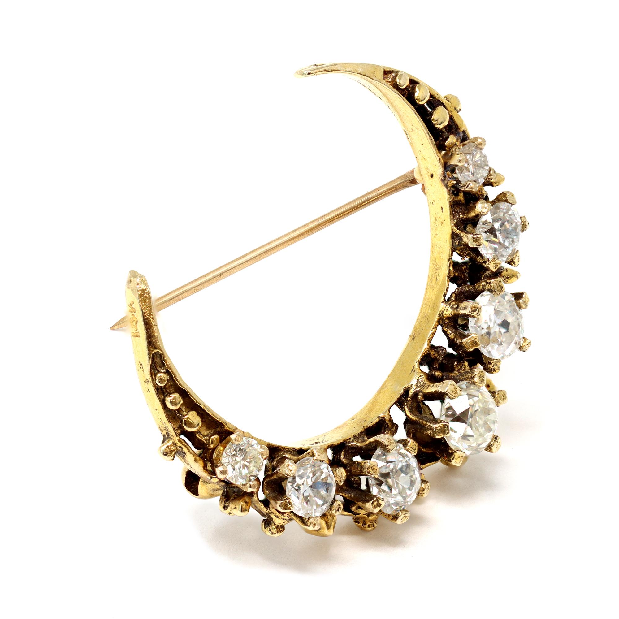 A staple of the Victorian jewelry, this crescent is a perfect example of gold craft from that period circa 1890-1900. The crescent is made in 14-karat yellow gold and features 7 graduated old mine-cut diamonds prong set. The estimated weight of the
