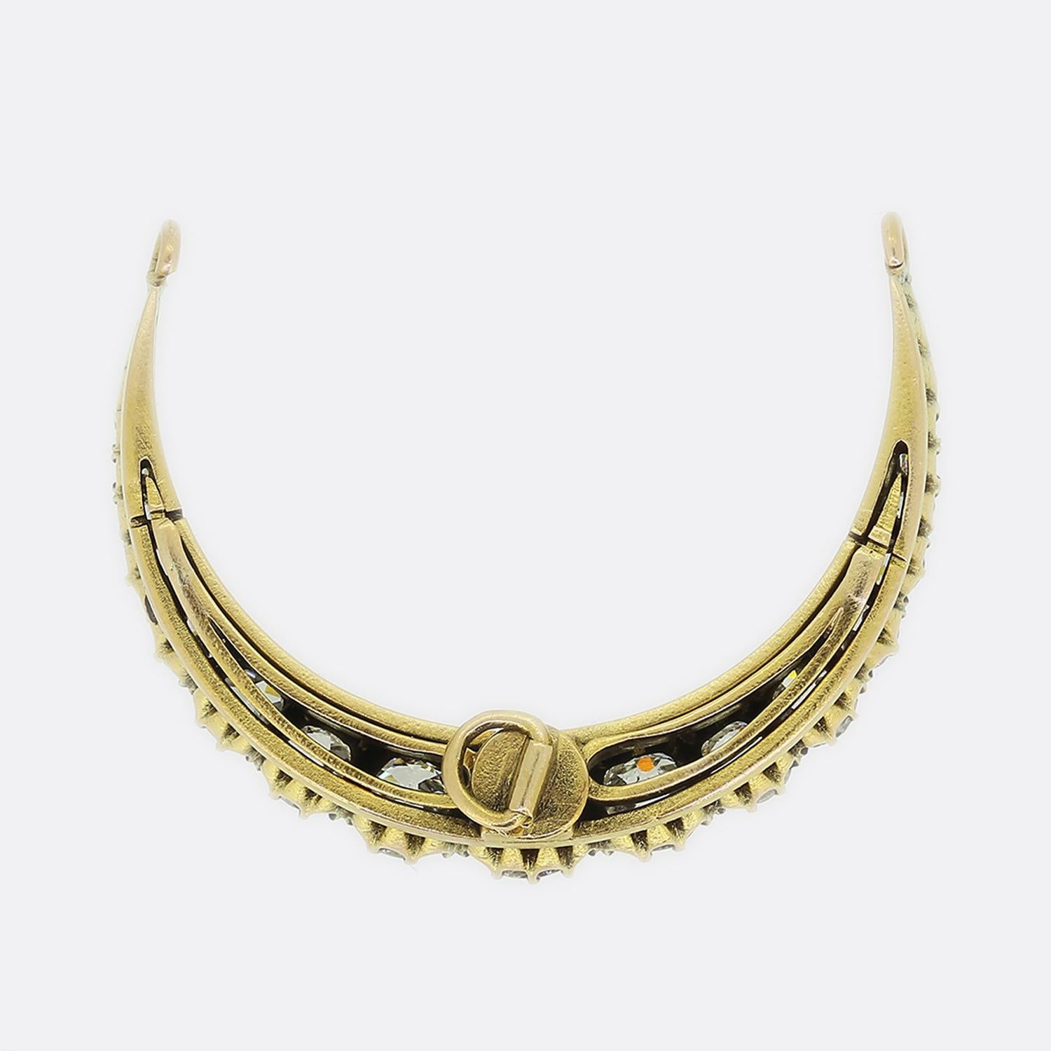 Here we have a charming crescent pendant. This antique piece has been crafted from a warm 15ct yellow gold and showcases a single row of round faceted old cut diamonds which graduate from rose cut diamond endings towards an impressive 0.50ct antique