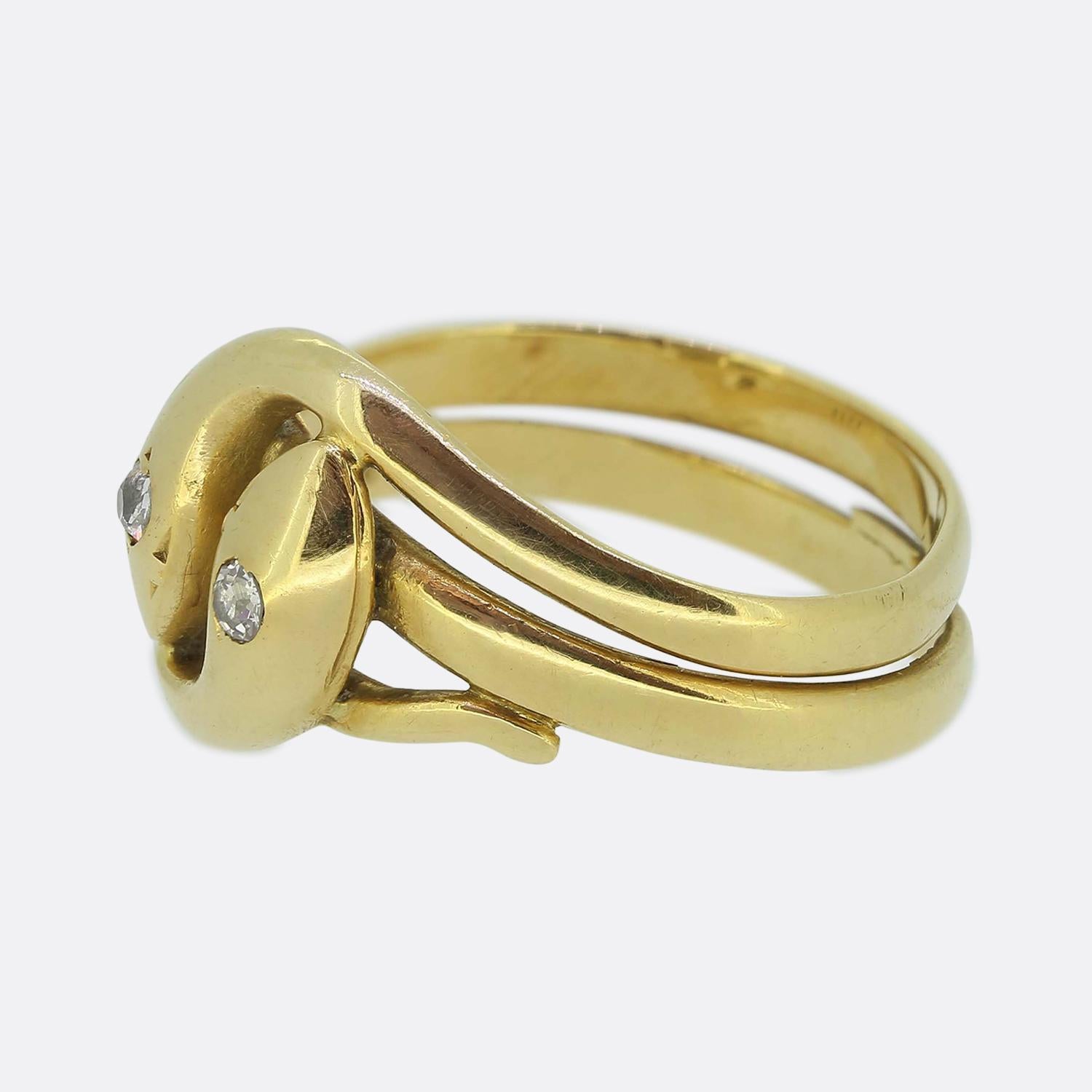 Here we have an 18ct yellow gold ring handcrafted with meticulous attention to detail portraying two entwined snakes; each of which is adorned with a dazzling white old European cut diamond at its head. The shank elegantly forms the sinuous bodies