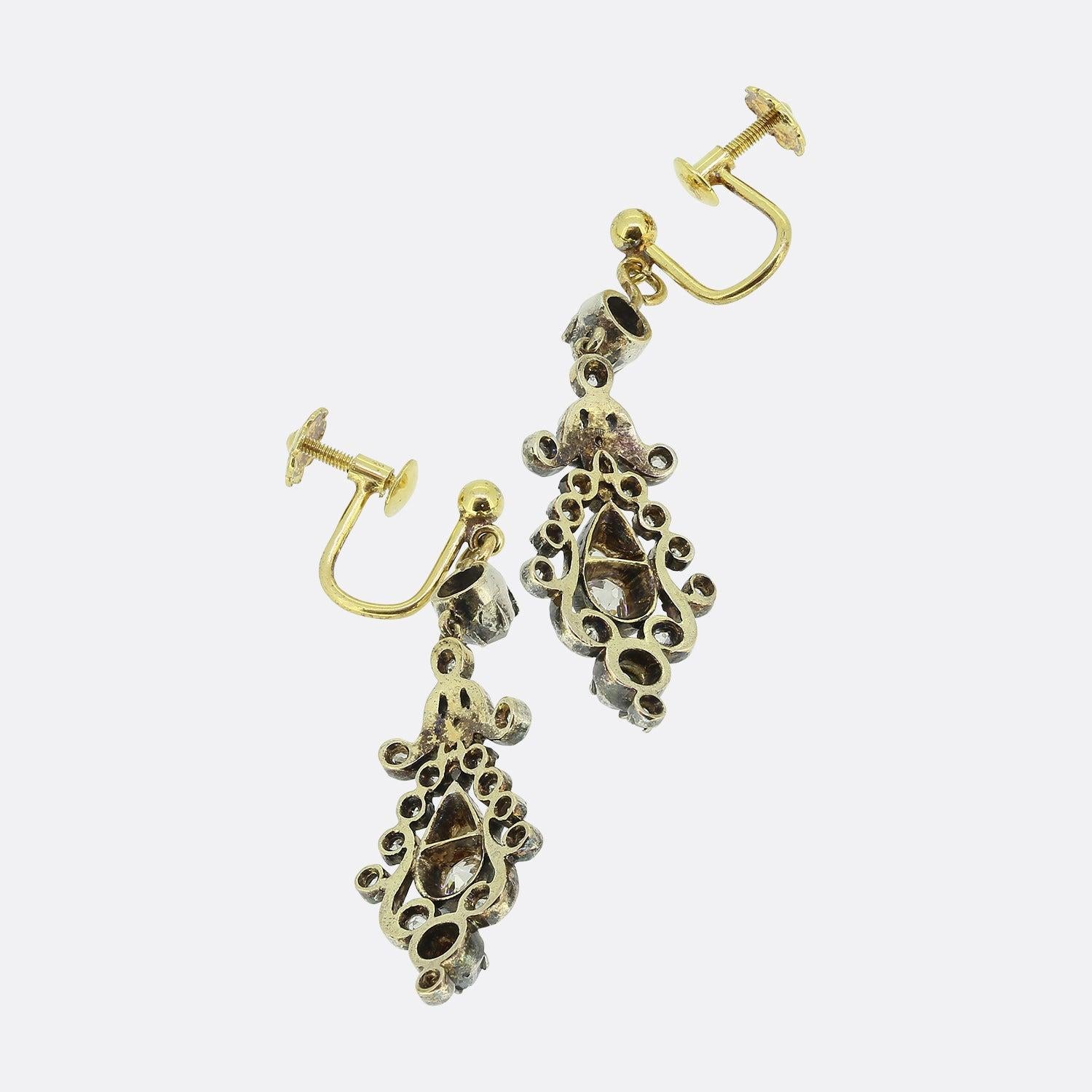 Here we have an outstanding pair of diamond drop earrings dating back to the early Victorian period. Each piece has been crafted from 18ct yellow gold into a curvaceous bell shape. Chunky old cushion cut diamonds can be found at the centre and