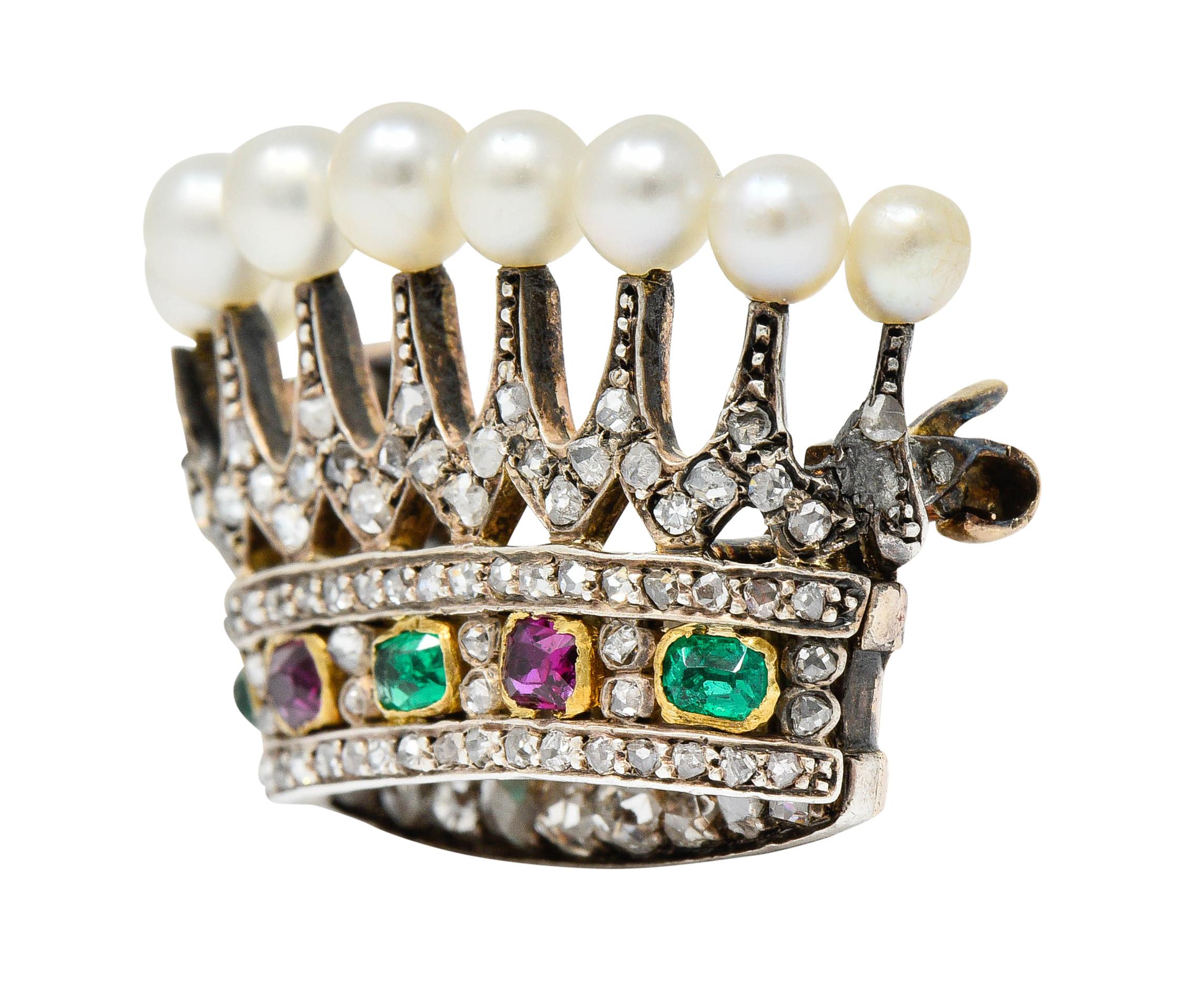 Brooch is designed as a silver-topped crown with each tine topped by 4.0 mm round pearl

Very well-matched with white body color and very good luster

With a row of emerald cut emeralds and rubies, alternating, and bezel set in gold

Vibrantly