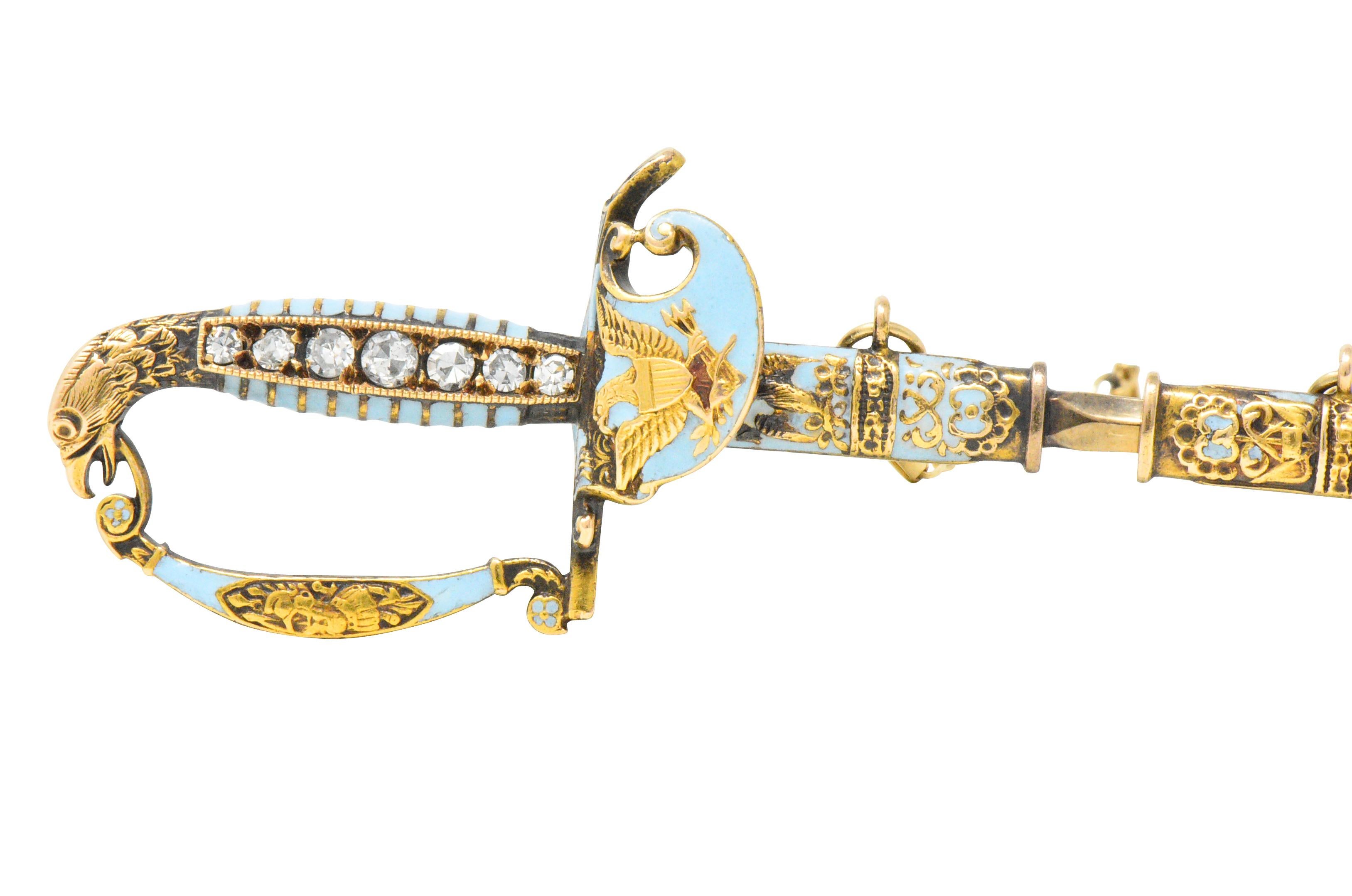 Designed as a military style saber with chain and removable sheath 

The handle is set with 7 single cut diamonds weighing approximately 0.18 carats total, eye-clean and white

With light blue enamel accenting, and engraved gold detail depicting