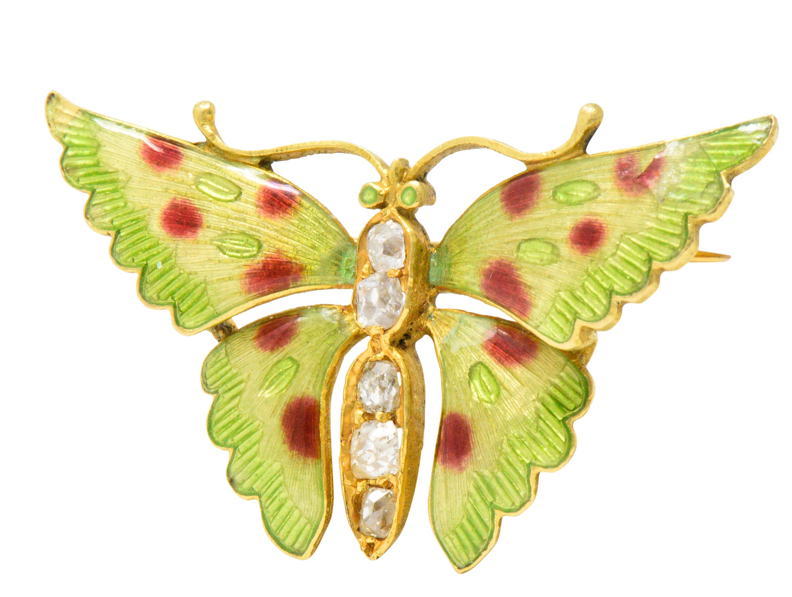 Butterfly whose body is accented with old mine cut diamonds weighing approximately 0.60 carats total, near eye-clean and white

Exquisite enameling in green, yellow and red adorn the wings and eyes

Tested as 14 karat gold

A nature lover's