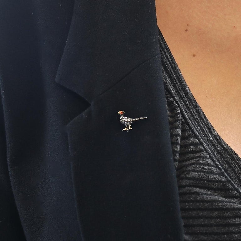 The perfect addition to any lapel. Livening up every outfit with mother natures natural beauty. Designed with old cut diamonds and enamel to create the charming bird motif. Crafted in 18k gold and silver. Accompanied with original box.