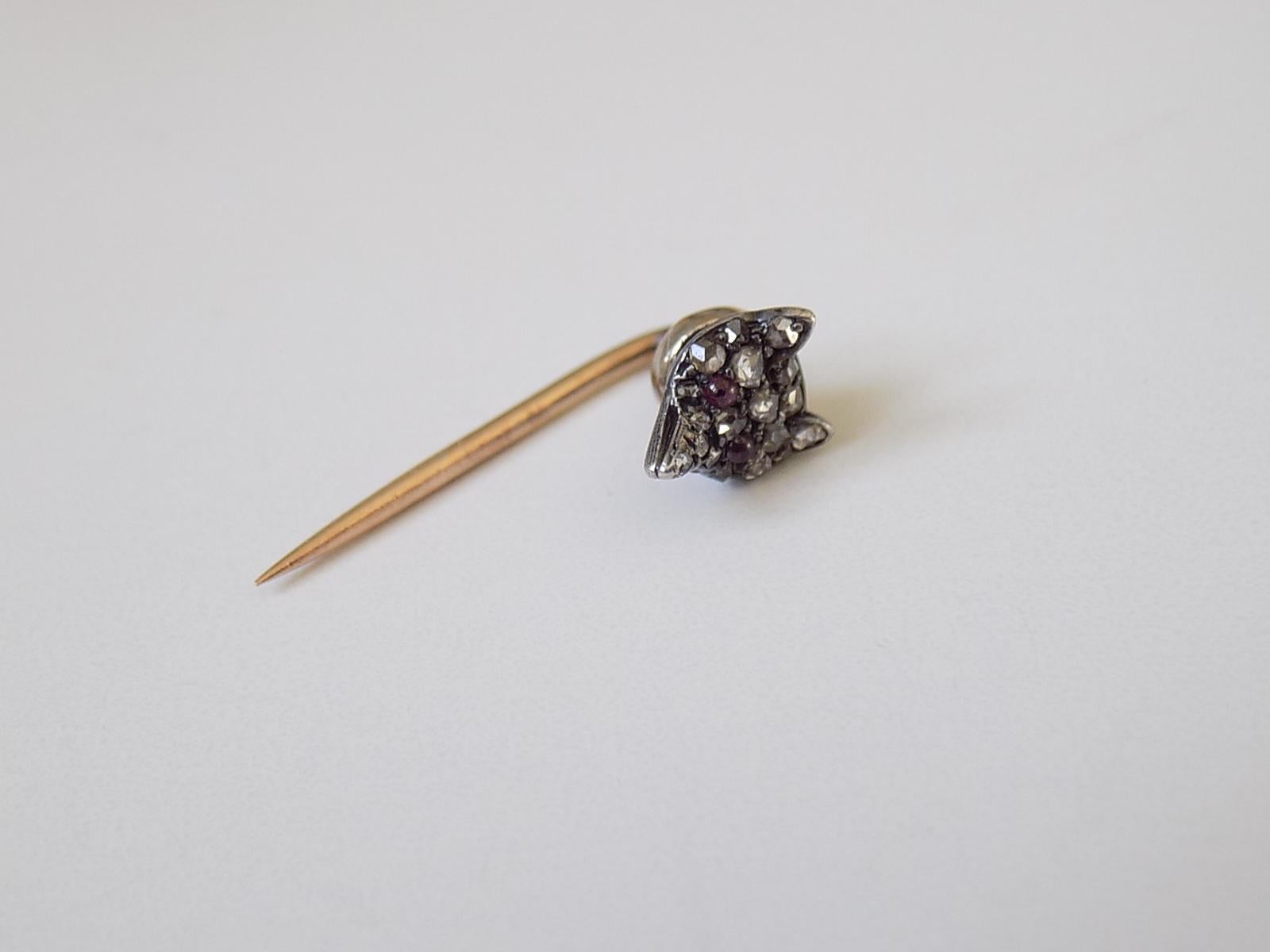 A Victorian c.1890 Rose cut Diamond Fox head Stick Pin or Cravat Pin in Silver and Rose Gold. English origin.
Width of the Fox head 6mm, height 8mm .
Total length of the pin  20mm.
Unmarked.
The pin in good condition for the age, fully complete with