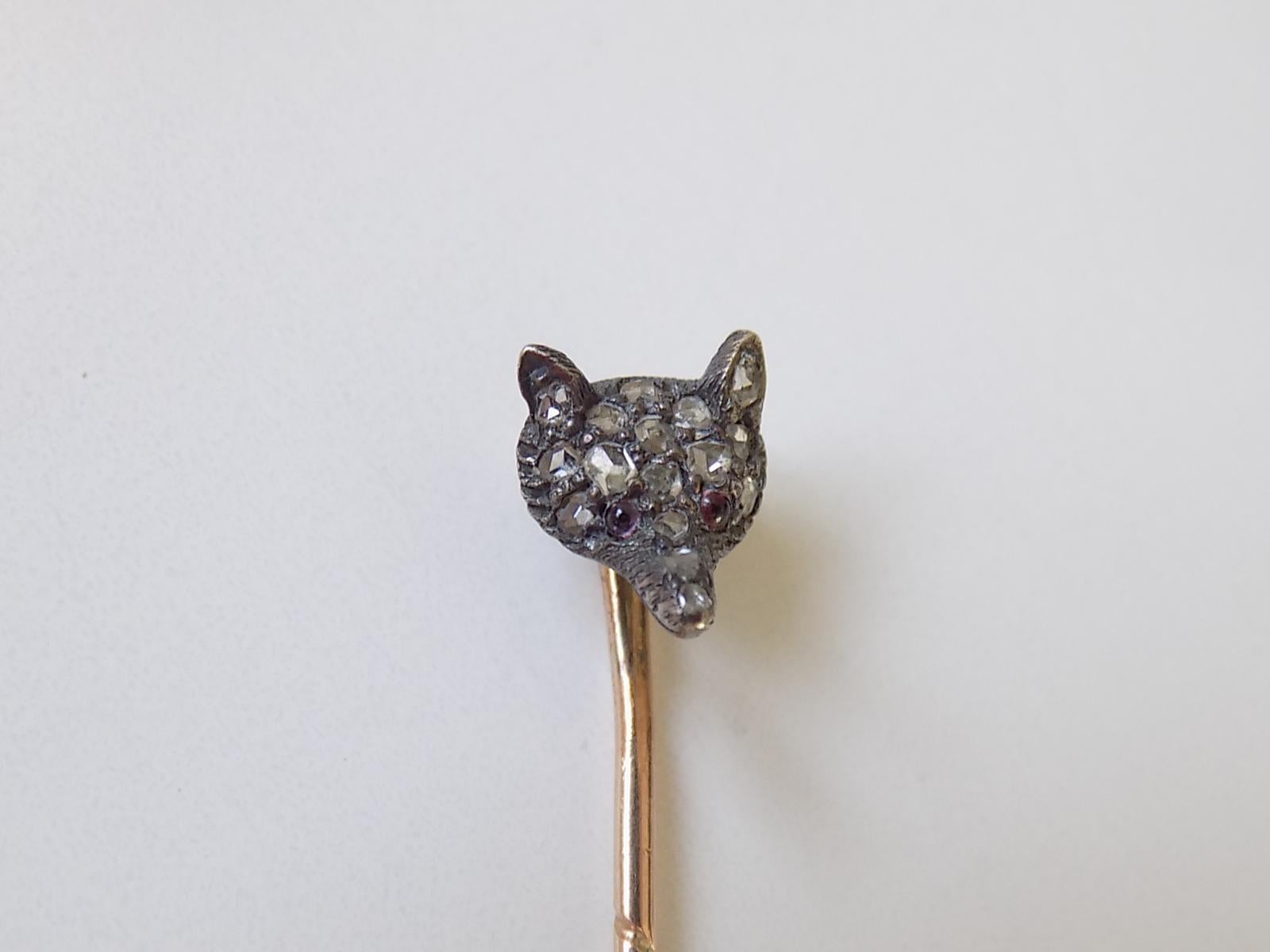 A Victorian c.1890 Rose cut Diamond Fox head Stick Pin in Silver and Rose Gold. English origin.
Width of the Fox head 7mm, height 10mm .
Total length of the pin  59mm.
Unmarked.
The pin in good condition for the age, fully complete with stones.
