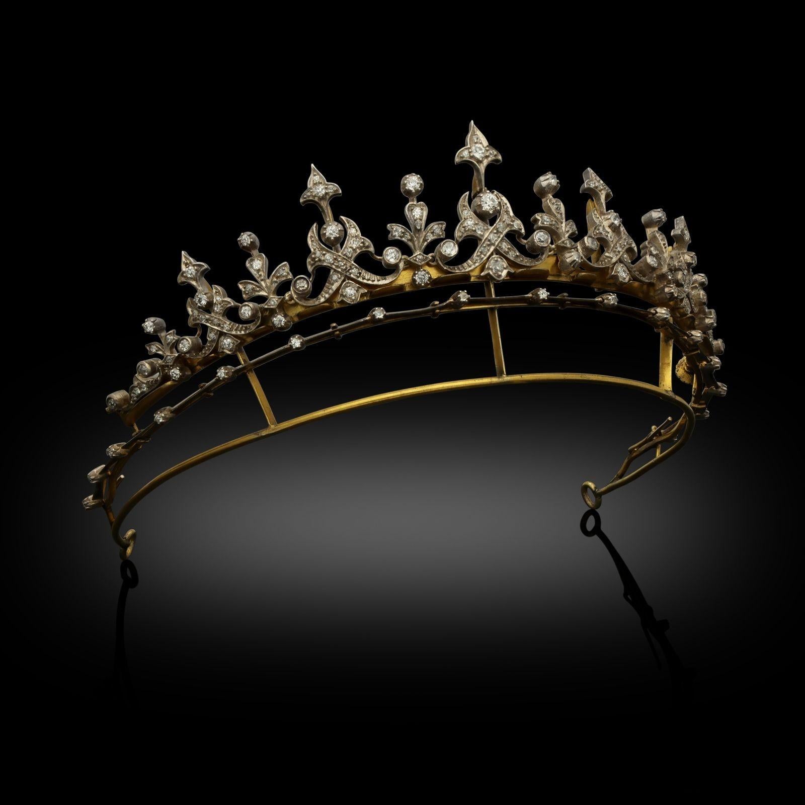 A beautiful Victorian diamond tiara convertible to a necklace c.1880s, the tiara formed of a graduated row of eleven fringe spires of foliate and scroll design with fleur-de-lys details, set throughout with old brilliant cut diamonds, the spires of