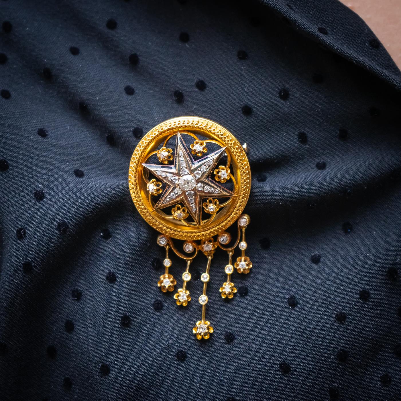 An Austrian antique diamond, gold and enamel suite, comprising a brooch, central old cut diamond set star, with a black enamel border, in an openwork, floral, diamond set surround, eith five diamond set tassel drops, together with a pair of matching