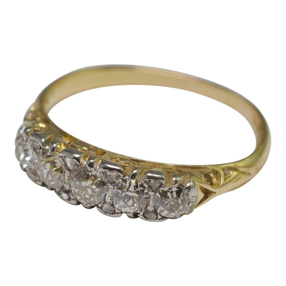 Victorian diamond 5 stone engagement ring on an 18ct gold carved hoop band.  The 5 chunky Old European cut diamonds weigh 0.66ct and are set with small diamond accents in silver, as was customary at that time.  The silver setting adds plenty of