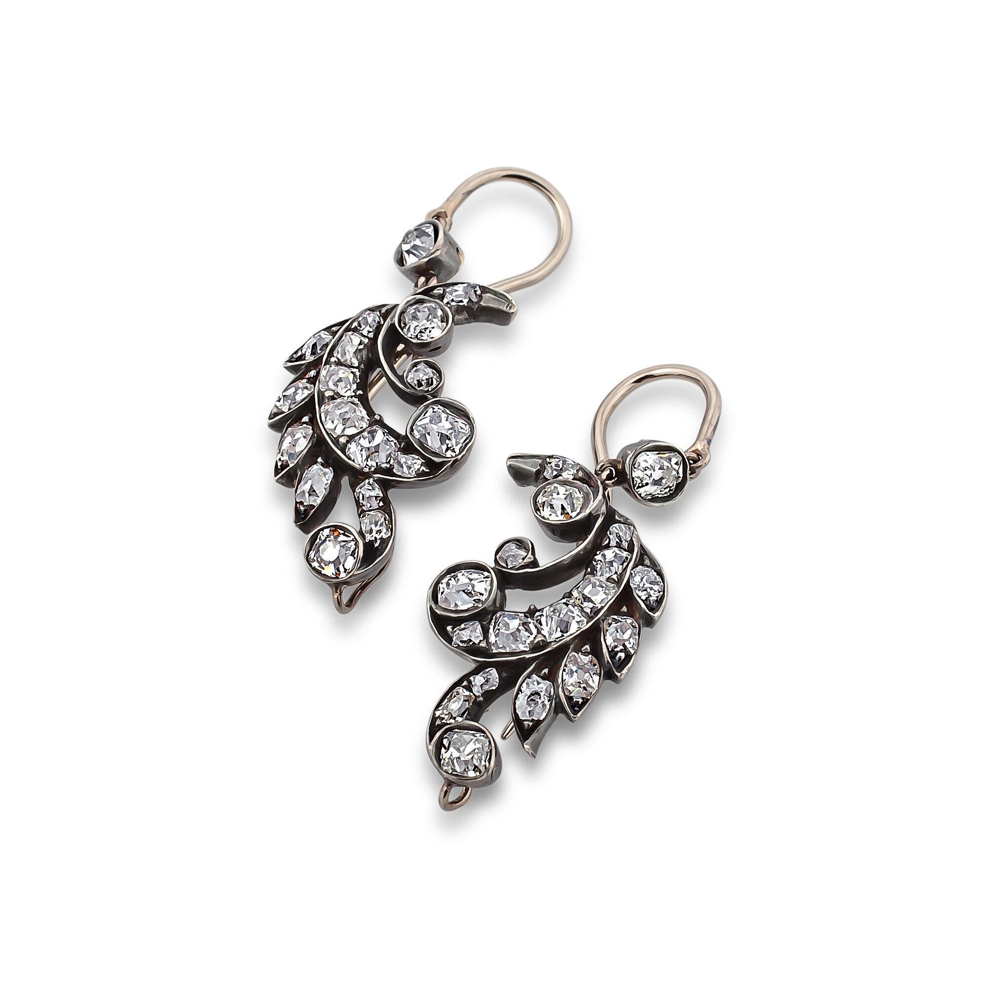 These Victorian handmade diamond, gold, and silver drop earrings will always keep you outdoor fresh.  With a total of approximately 1.00 carat of round cut diamonds mounted in blackened silver, these graceful and elegant leaf earrings look as though