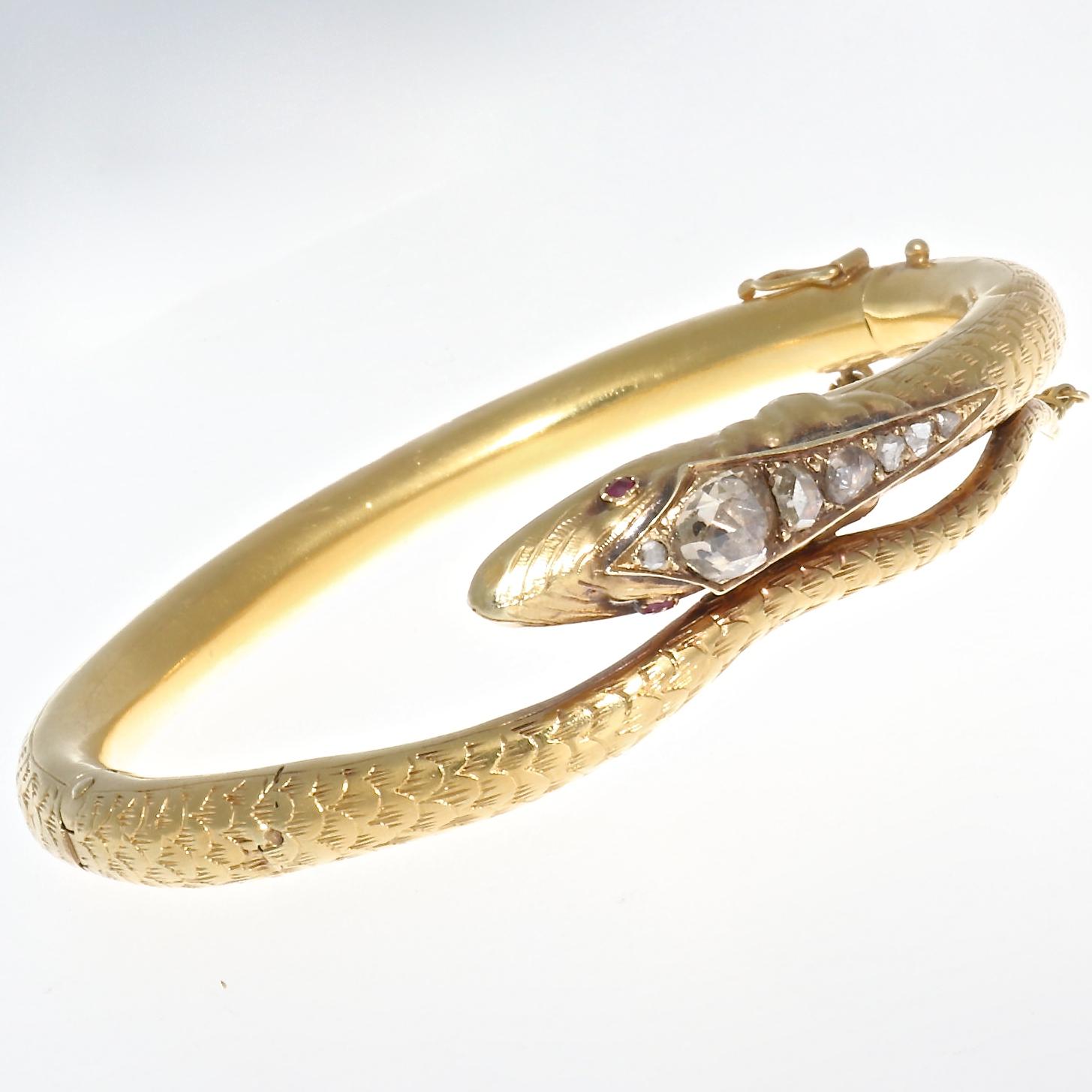 Exquisite 18k yellow gold Victorian snake bangle from Holland, circa 1880. Featuring 6 rose cut diamonds approximately H-I in color, adorning the perfectly sculpted head of the snake, and total approximately one carat. With ruby eyes that are