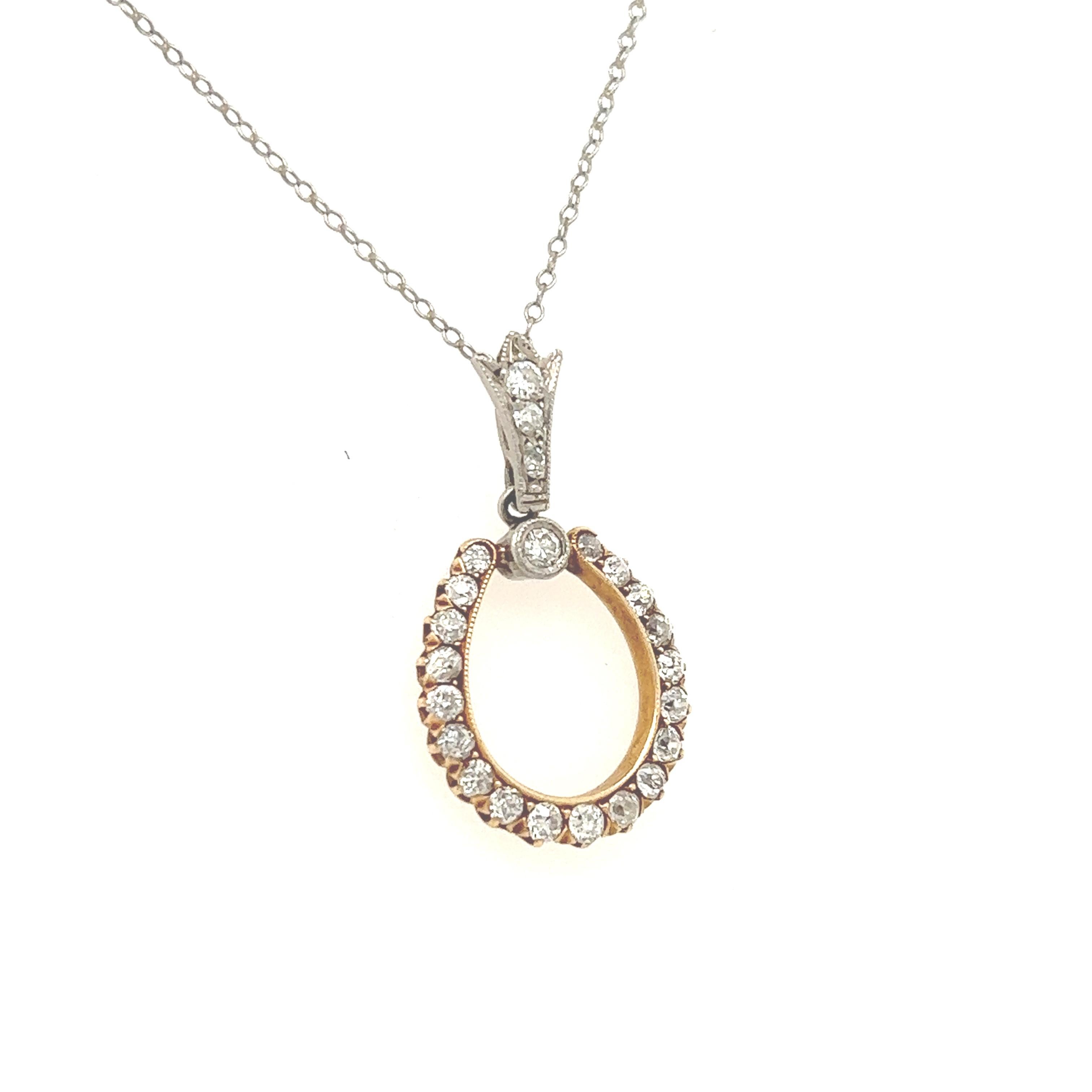 Fantastic treasure from the Victorian era. The necklace shows a horse shoe pendant crafted in yellow gold & platinum. The pendant is set with old mine cut diamonds that graduate in size in the design. The diamonds are white in color showing Vs/Si