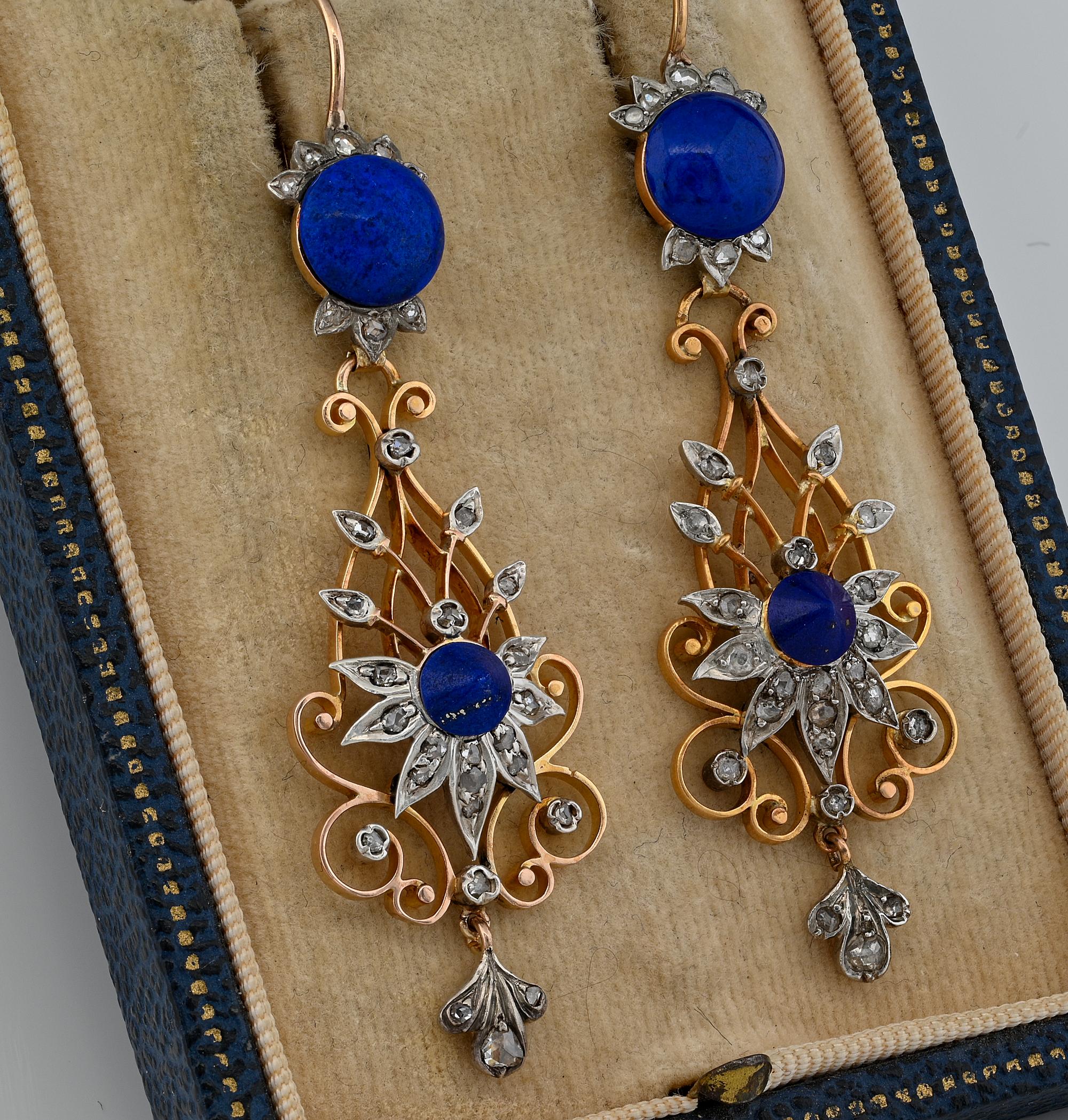 These fantastic pair of Victorian earrings are 1880 ca
Designed as long drop pendants with unique open work made of solid 18 Kt gold, enhanced over the front side with a flower motif set with a centre conical cut Lapis of intense Royal Blue