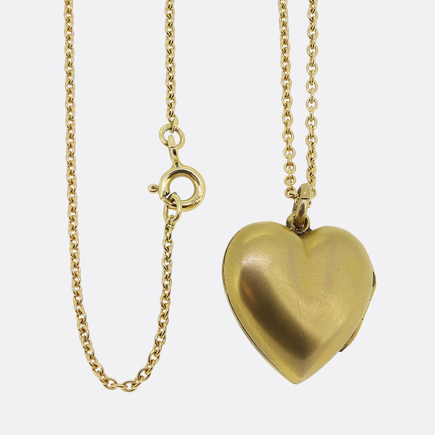 Here we have a charming diamond locket necklace. This antique locket has been crafted from 15ct yellow gold into the the shape of a love heart and showcases a fine matte finish. This pendant has then been expertly set with a single rose cut diamond