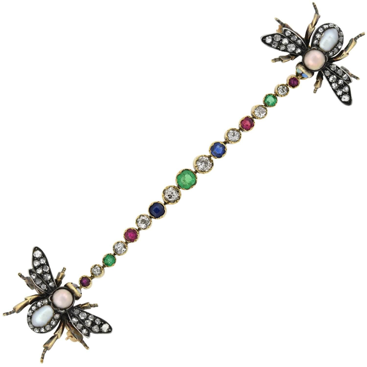 An exceptional and unusual multi-gemstone insect scatter pin from the Victorian (ca1880) era! This stunning piece is comprised of two matching open-winged insect pins linked together by a fantastic gemstone flexible link. All three parts are crafted