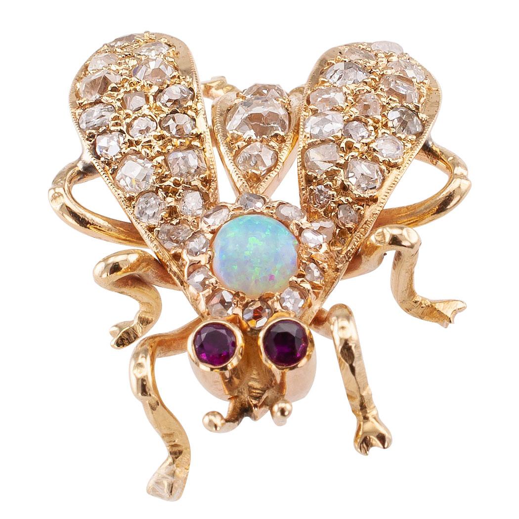 Victorian diamond opal ruby and gold bee brooch circa 1890. The bee design features ruby eyes, an opal head crowned by rose-cut diamonds, and old mine-cut diamonds over the abdomen and wings, the diamonds totaling approximately 1.62 carats, mounted