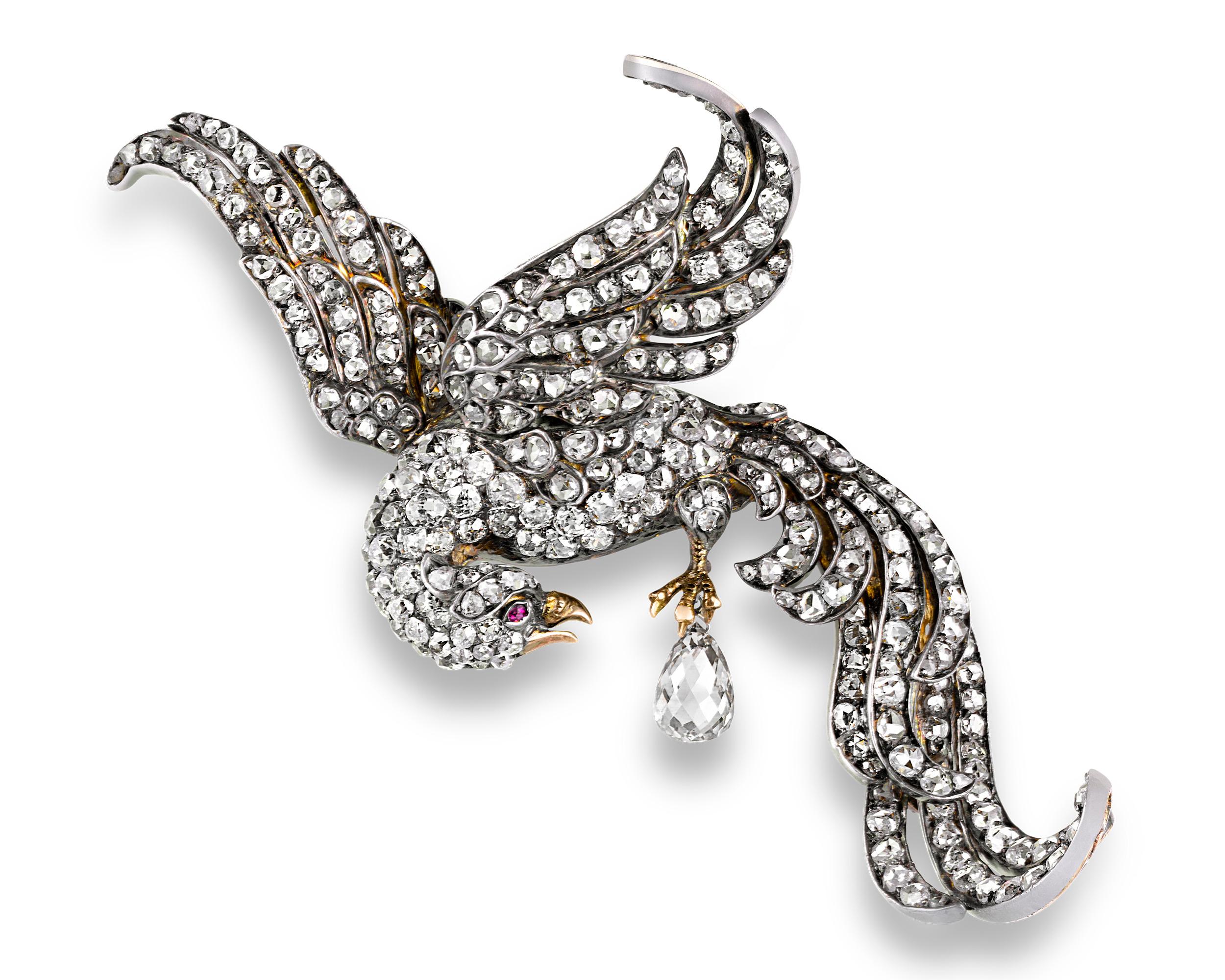 An array of Old Mine-cut diamonds are featured in this antique brooch that takes the form of a graceful white peacock, given life with a ruby eye. Set in gold over silver, the piece almost certainly dates to the Victorian era, an age named for Queen