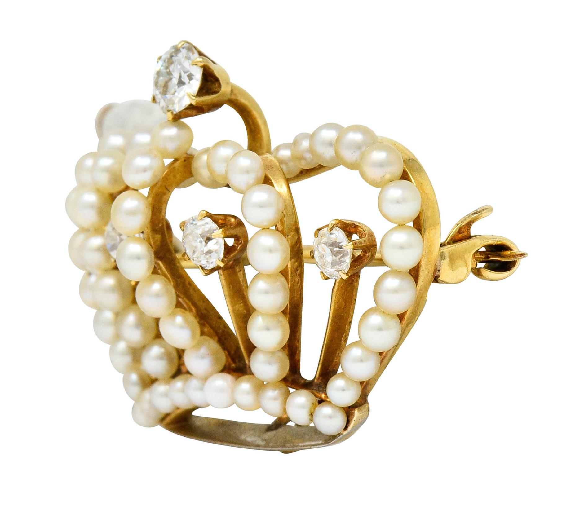 Pendant brooch designed as a dimensional crown with its outline comprised of natural pearls that measure 2.0 to 2.5 mm

With well-matched cream body color and excellent luster with some silver and rosè overtones

Four tines and top of crown accented