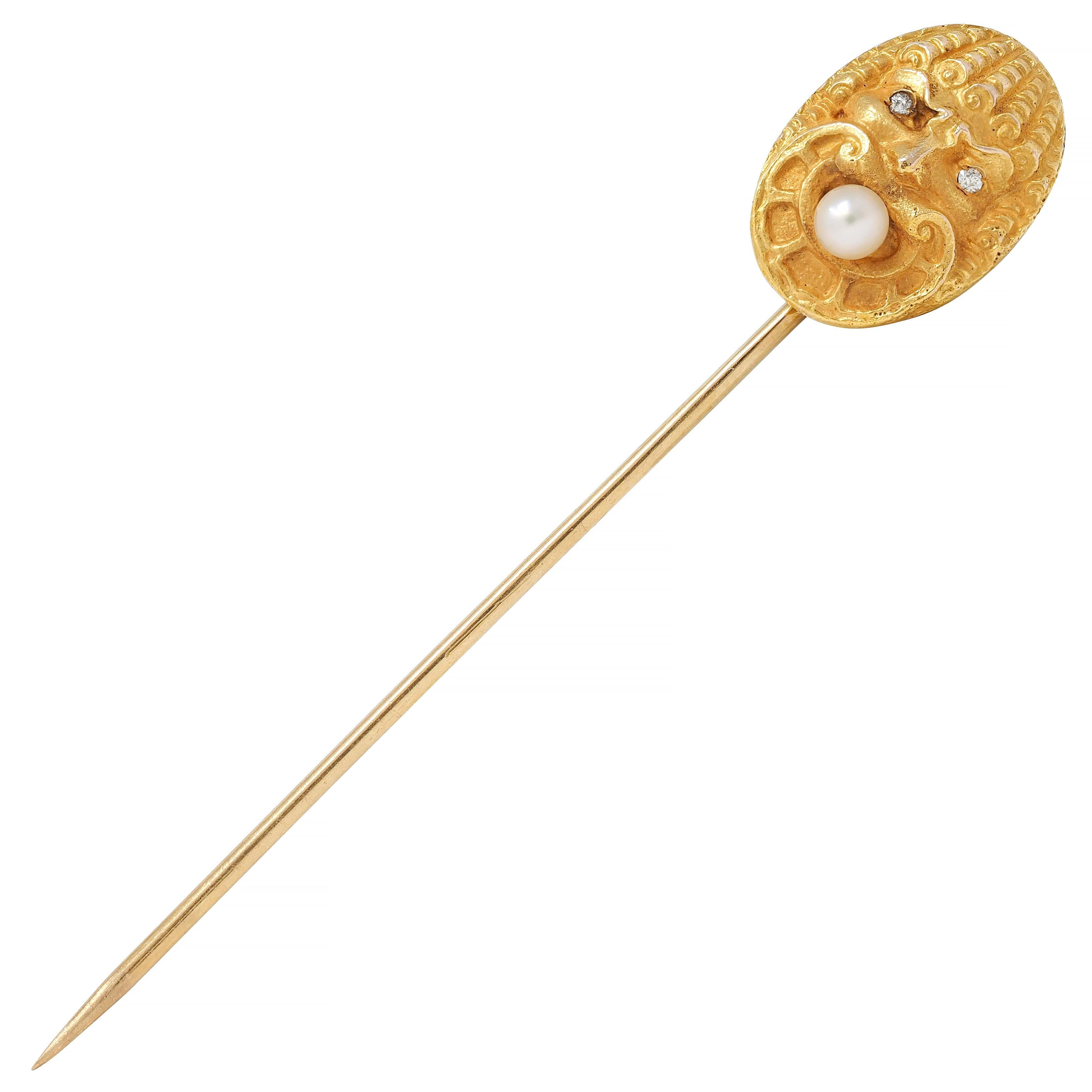 Designed as an oval shaped highly rendered God of Wind bust
With coiled hair, scrolling beard, and furrowed brow
Eyes are flush set single cut diamonds - eye clean and bright
Accented by a 3.5 mm round pearl in mouth
White with moderate