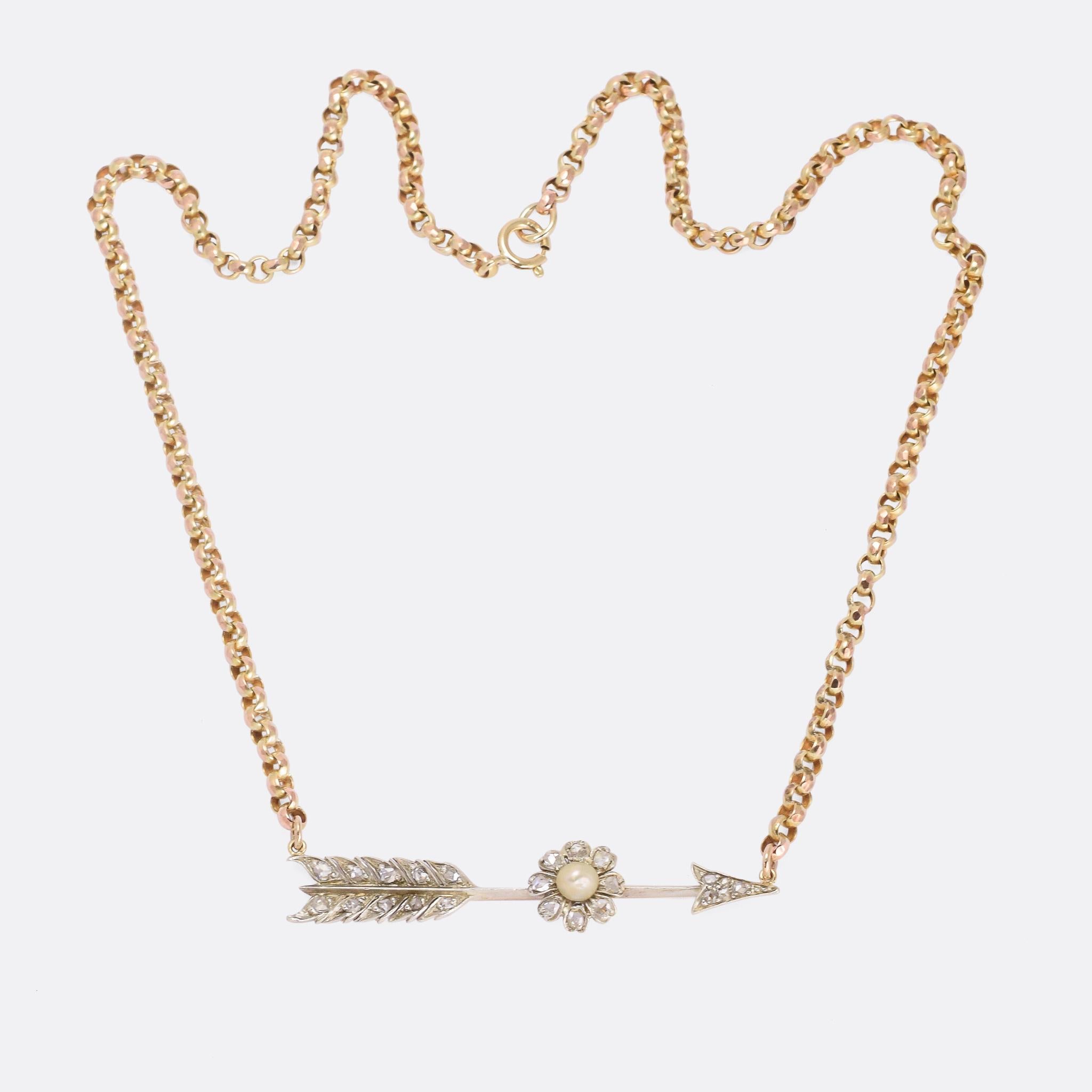 A superb antique arrow necklace dating from the mid Victorian era, circa 1870. We've added a period belcher chain in 9 karat gold with round faceted links. The arrow itself is set with rose cut diamonds and features a flower in the middle with
