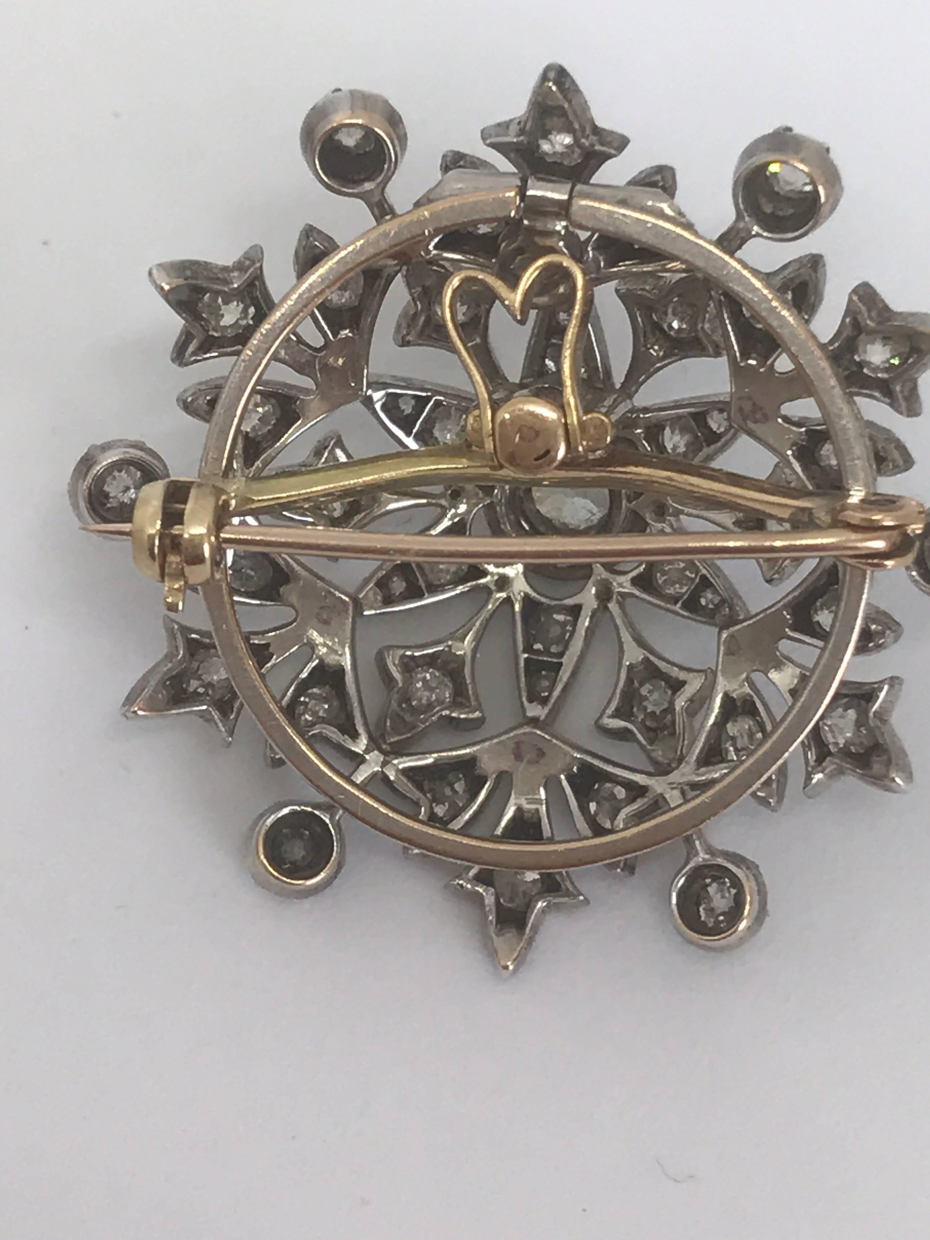 A Victorian 18k gold pendant brooch set with a central 0.6ct rose cut diamond and surrounded by smaller rose cut  diamonds totalling about 2.5-3cts. The brooch has a screw back so it can be removed when wearing it as a pendant and the pendant loupe