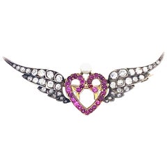 Antique Victorian Diamond Ruby and Pearl Silver and Yellow Gold Winged Heart Brooch