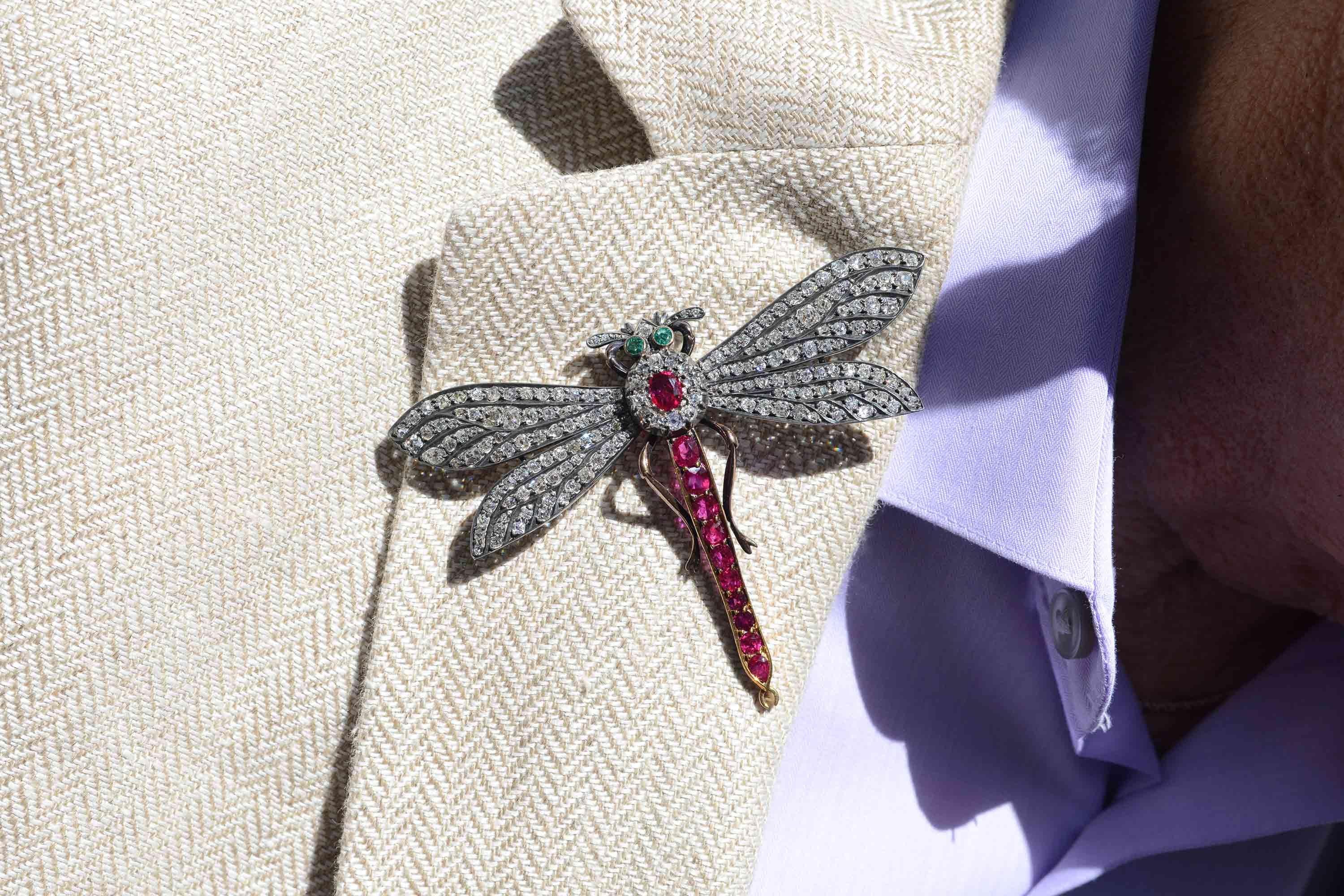 Let this stunning, authentic, 140 year old antique Victorian dragonfly brooch whisk you away on its shimmering, diamond embedded wings. Boasting 6 carats of old mine cut diamonds and adorned with 3 carats of deep, purplish-red rubies with