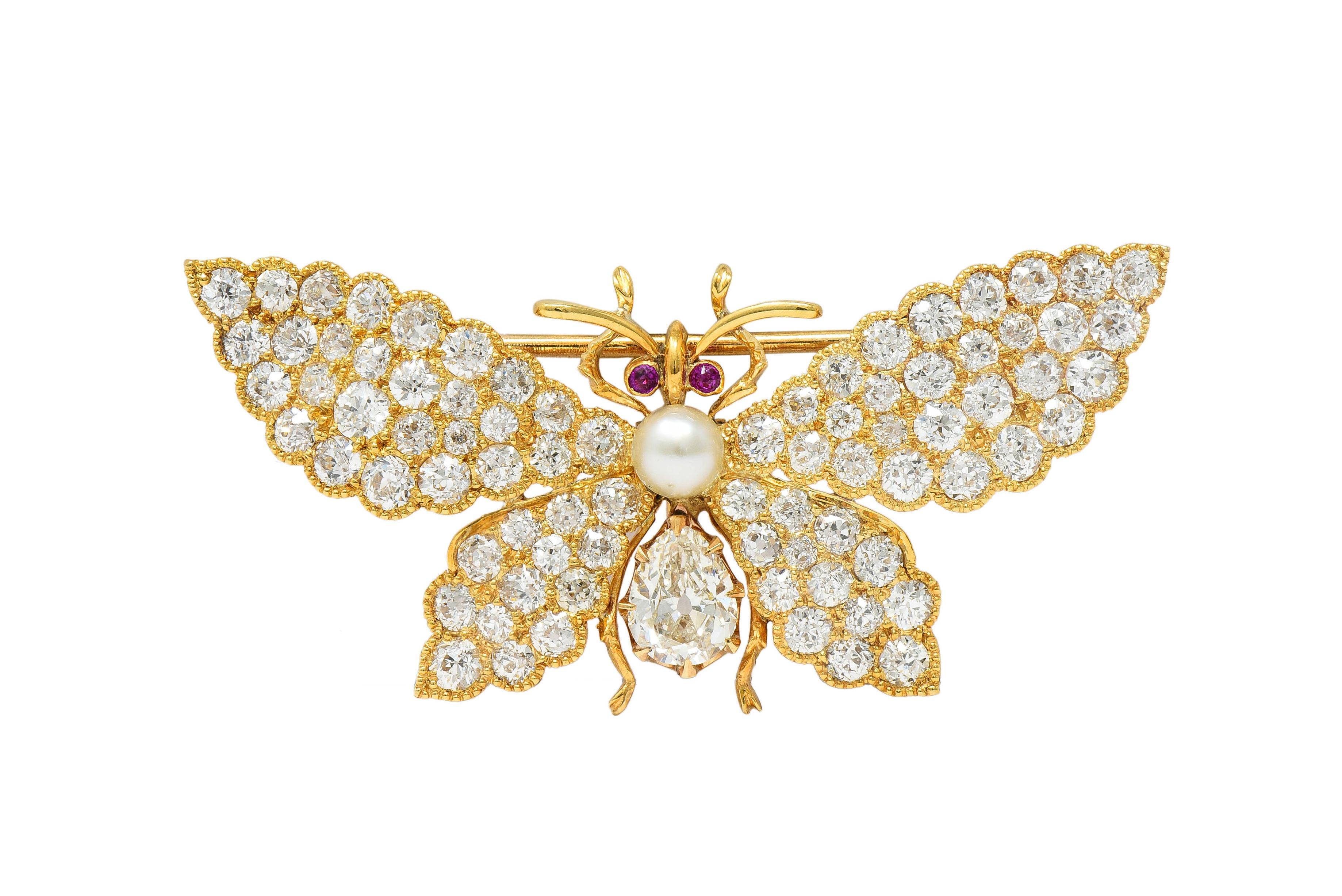 Designed as a stylized butterfly with scalloped wings, curling antennae, and spindly legs 
Featuring a pear cut diamond prong set as lower body weighing approximately 0.65 carat
I color with VS2 clarity - set below a 4.0 mm round pearl as the torso