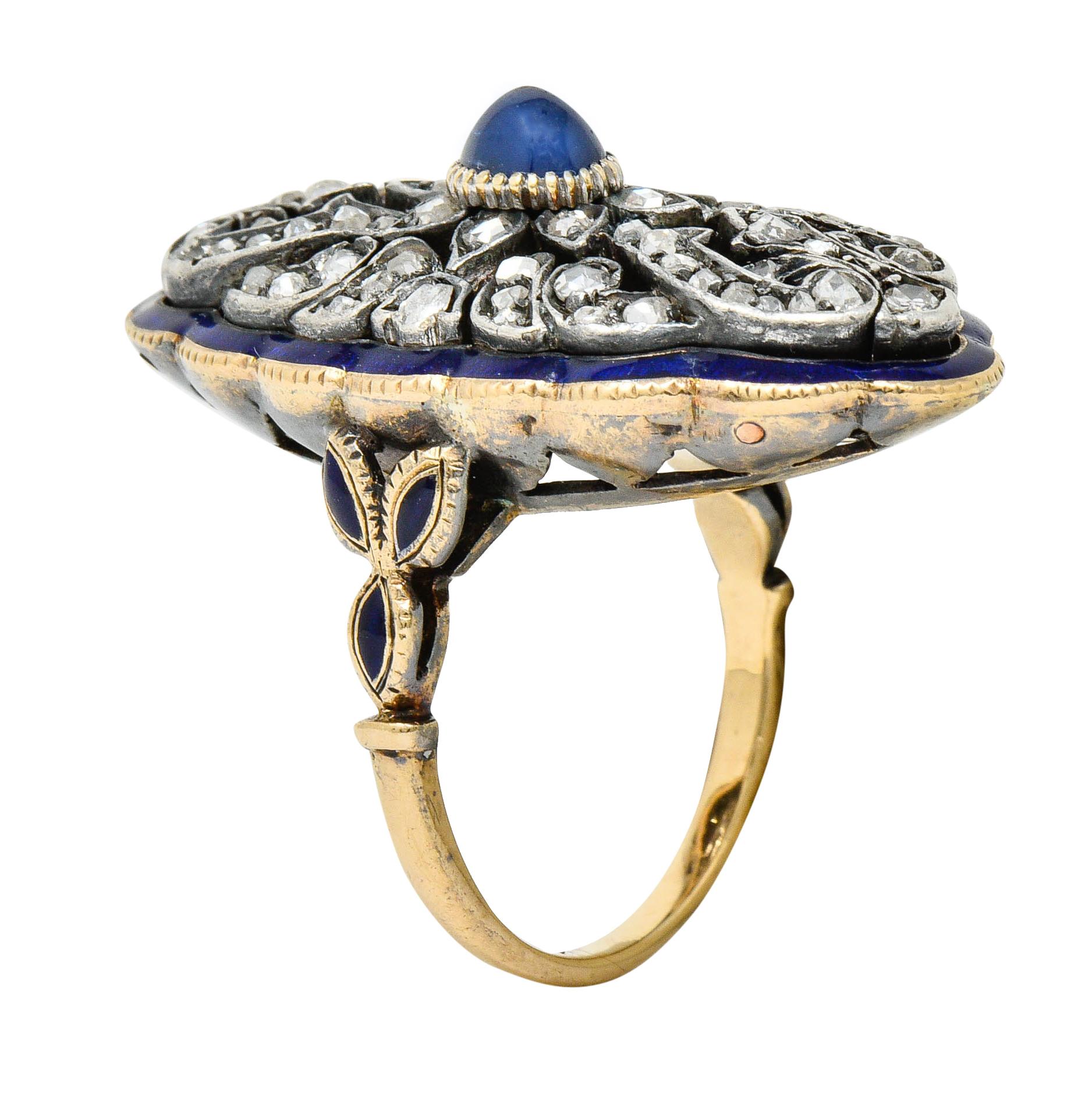 Decorative dinner ring centers an oval sapphire cabochon weighing approximately 0.72 carat

Surrounded by a flourishing silver design accented by rose cut diamonds

With a royal blue enamel border and foliate shoulders; well-matched to sapphire and