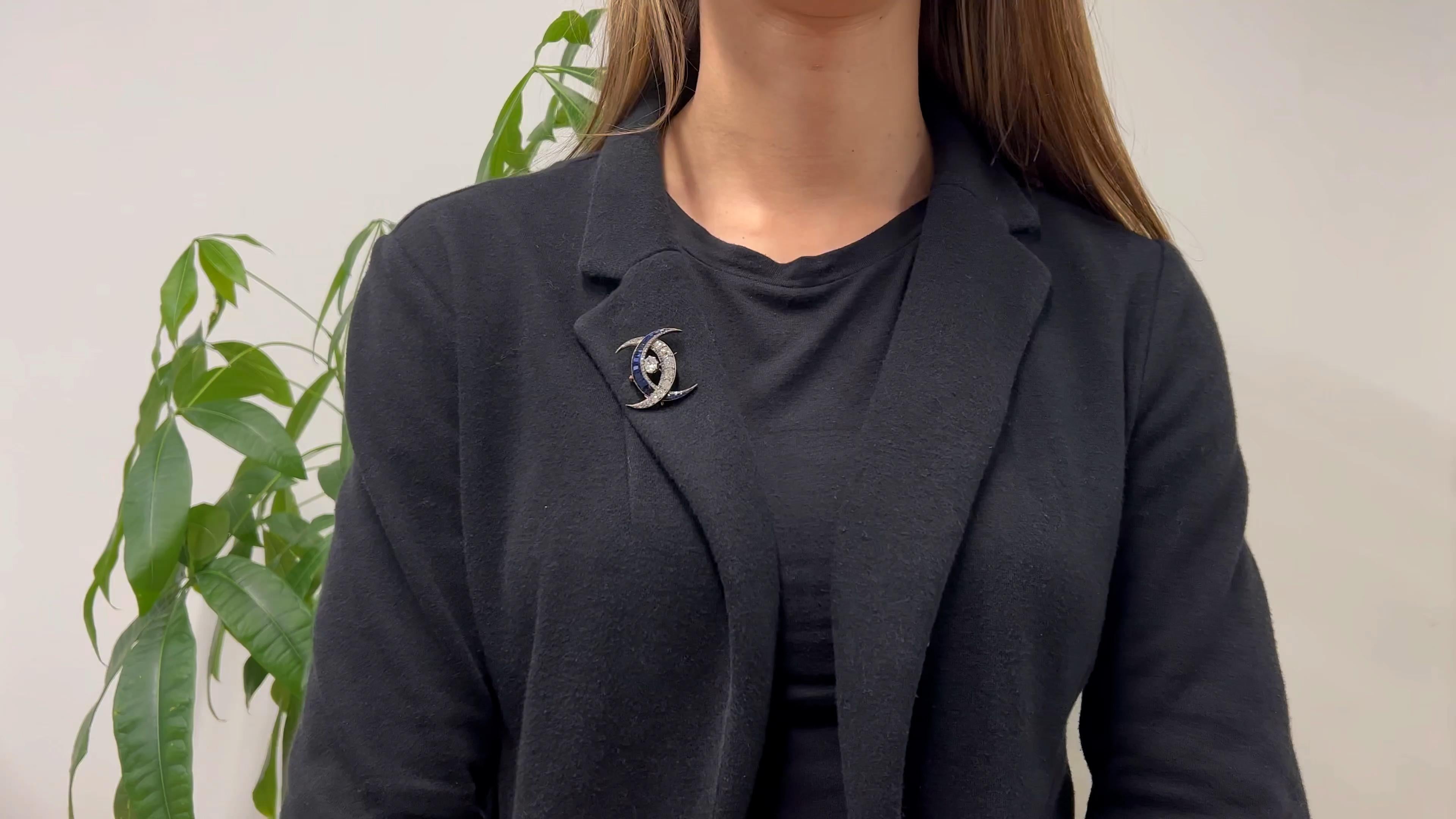 One Victorian Diamond Sapphire Silver 18k Rose Gold Double Crescent Moon Brooch Pendant. Featuring one old mine cut diamond weighing approximately 1.05 carats, graded K color, SI1 clarity. Accented by 48 mixed cut sapphires with a total weight of