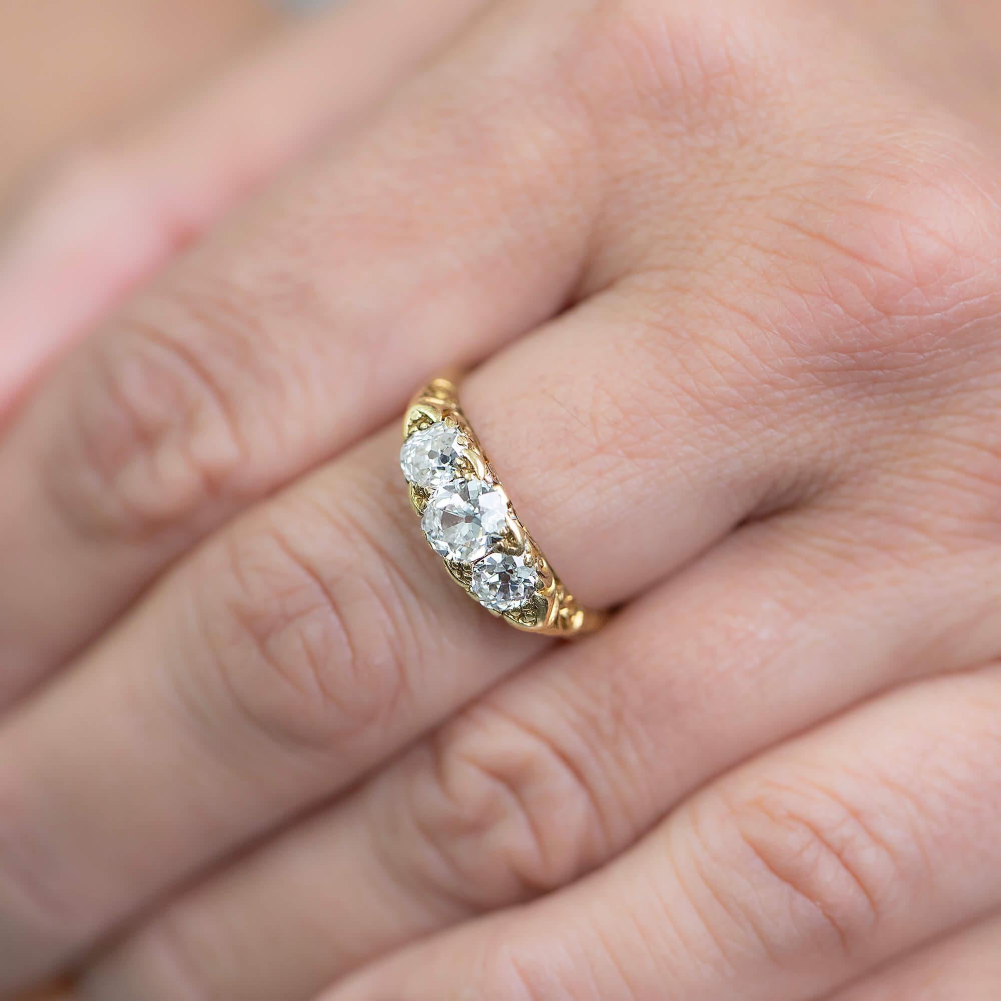 This is a beautiful Victorian, scrolled half hoop design, set with three old mine cut diamonds, hand-crafted in 18k yellow gold.
The half hoop is a lovely style of ring, sitting across the top of the finger, making the most of this space by filling