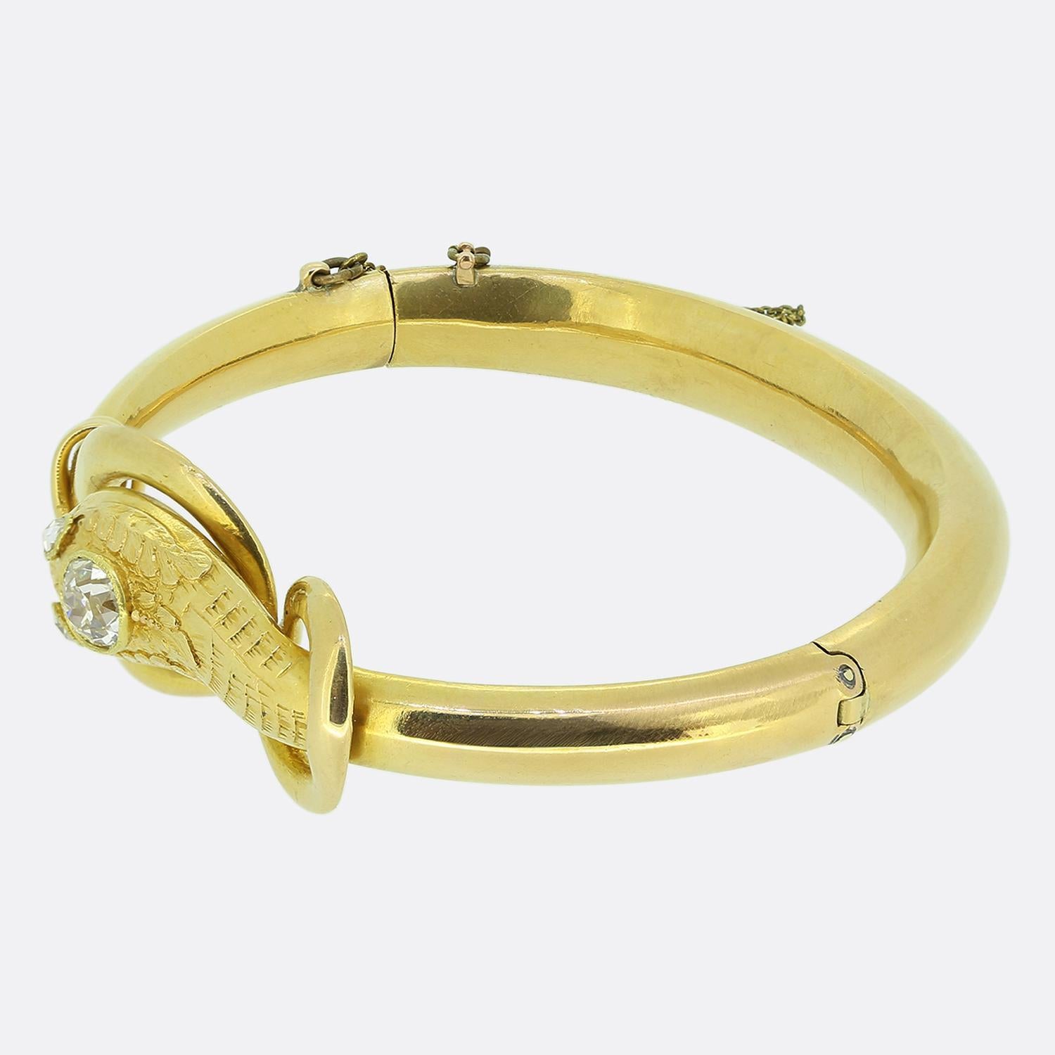 Here we have a fabulous diamond snake bangle dating back to the Victorian period. This antique piece has been crafted from a rich 18ct yellow gold into the shape of a coiled snake with the head subtly poking through the double opening of the
